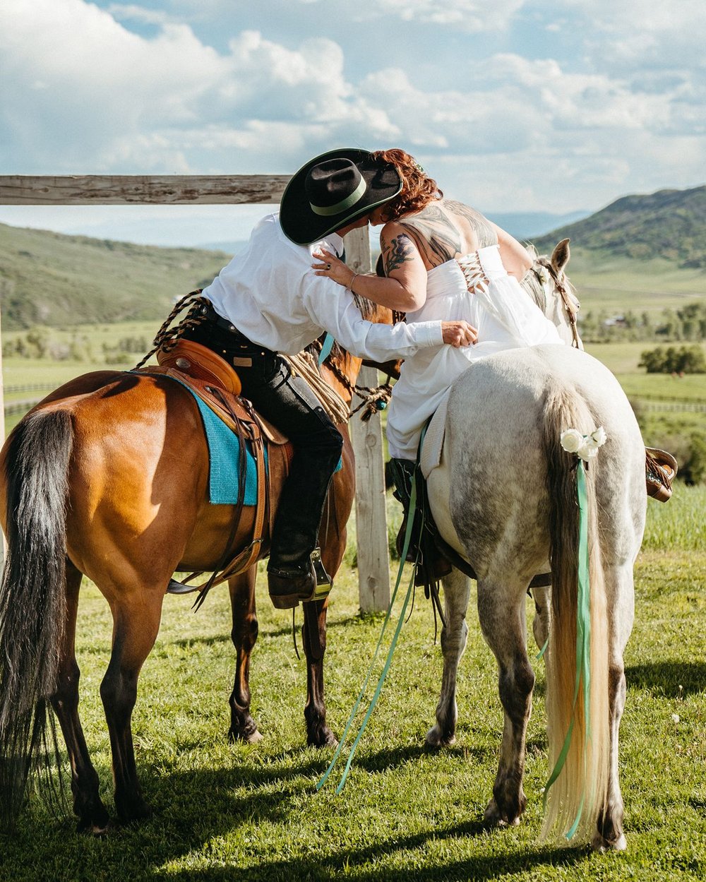 Couple kissing on horseback