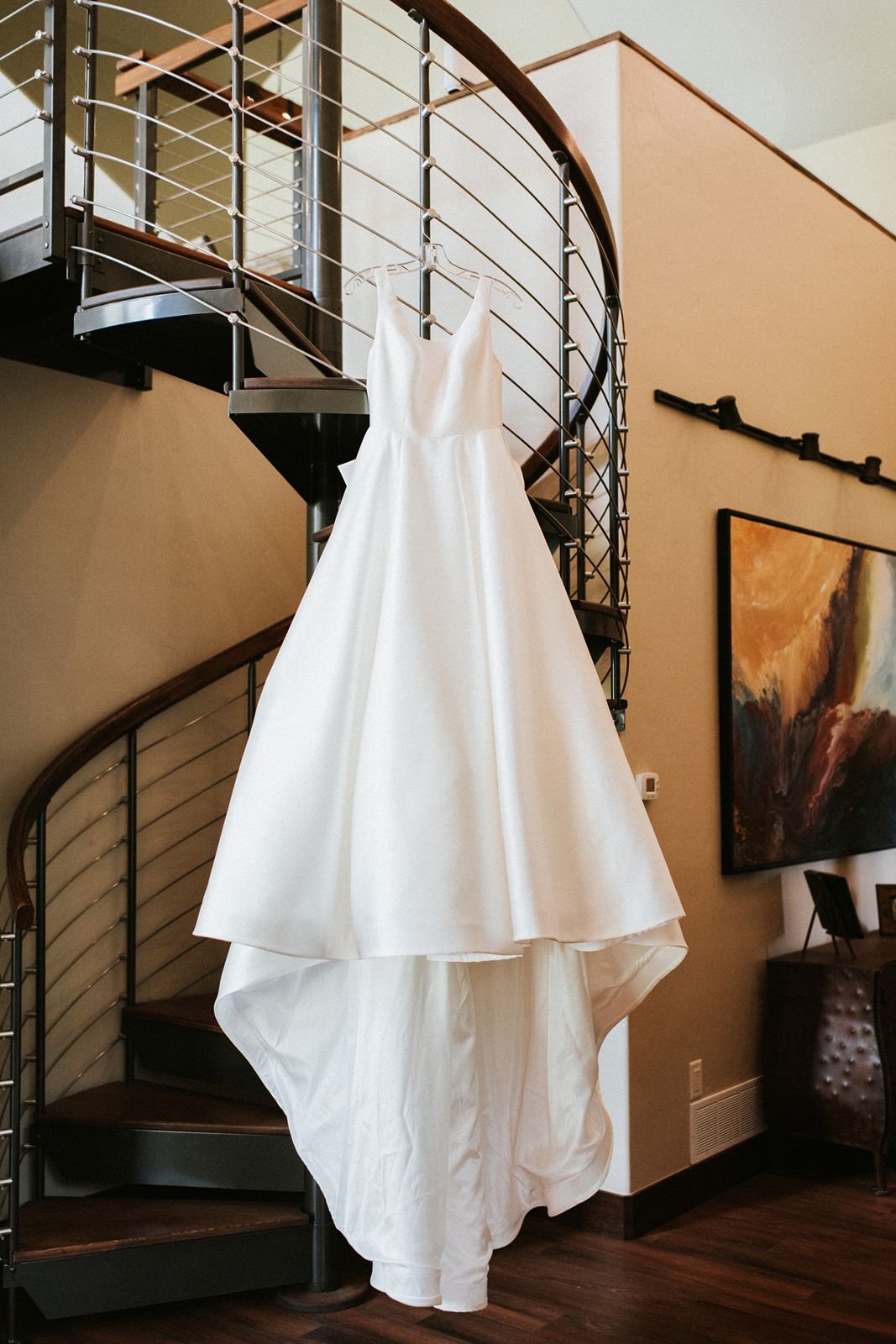 wedding dress hanging from circular staircase