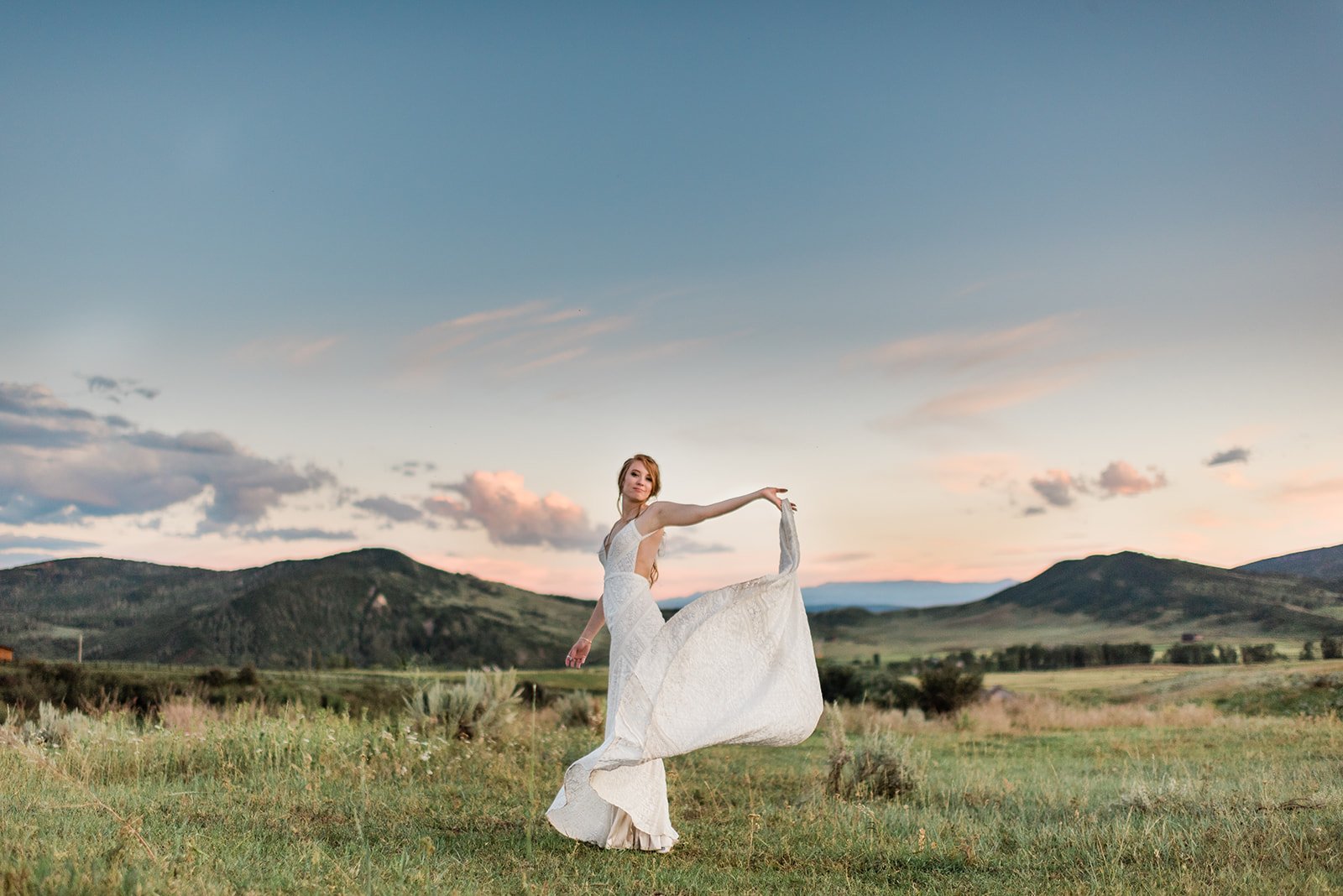 bride twirling in meadow denver