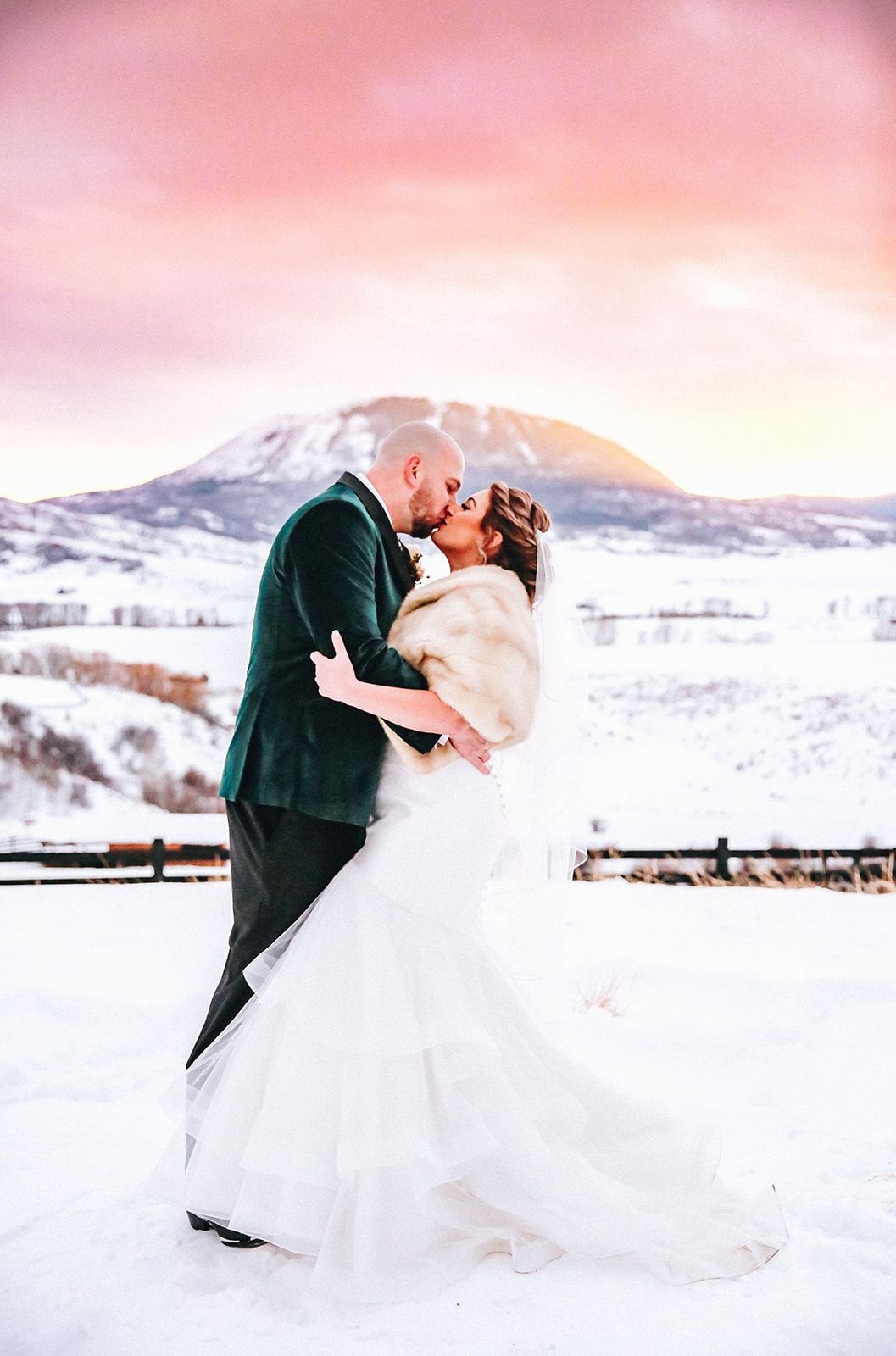 Winter couple kissing at sunset