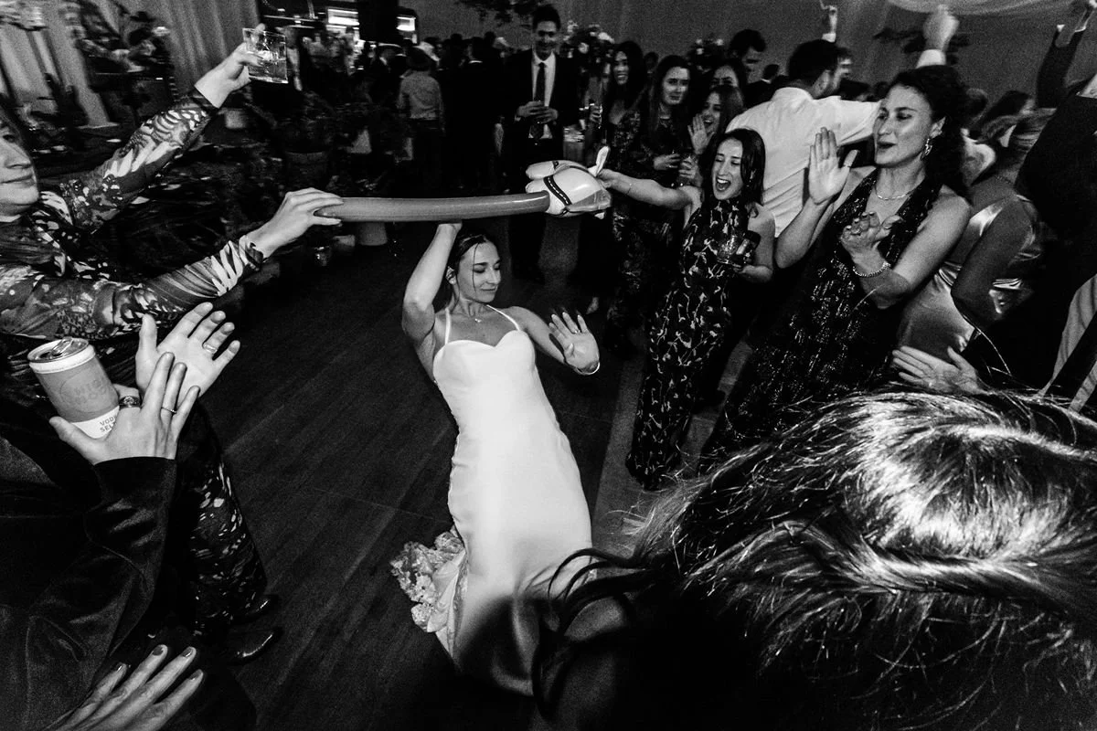 bride doing limbo at reception for winter destination wedding in Steamboat Springs
