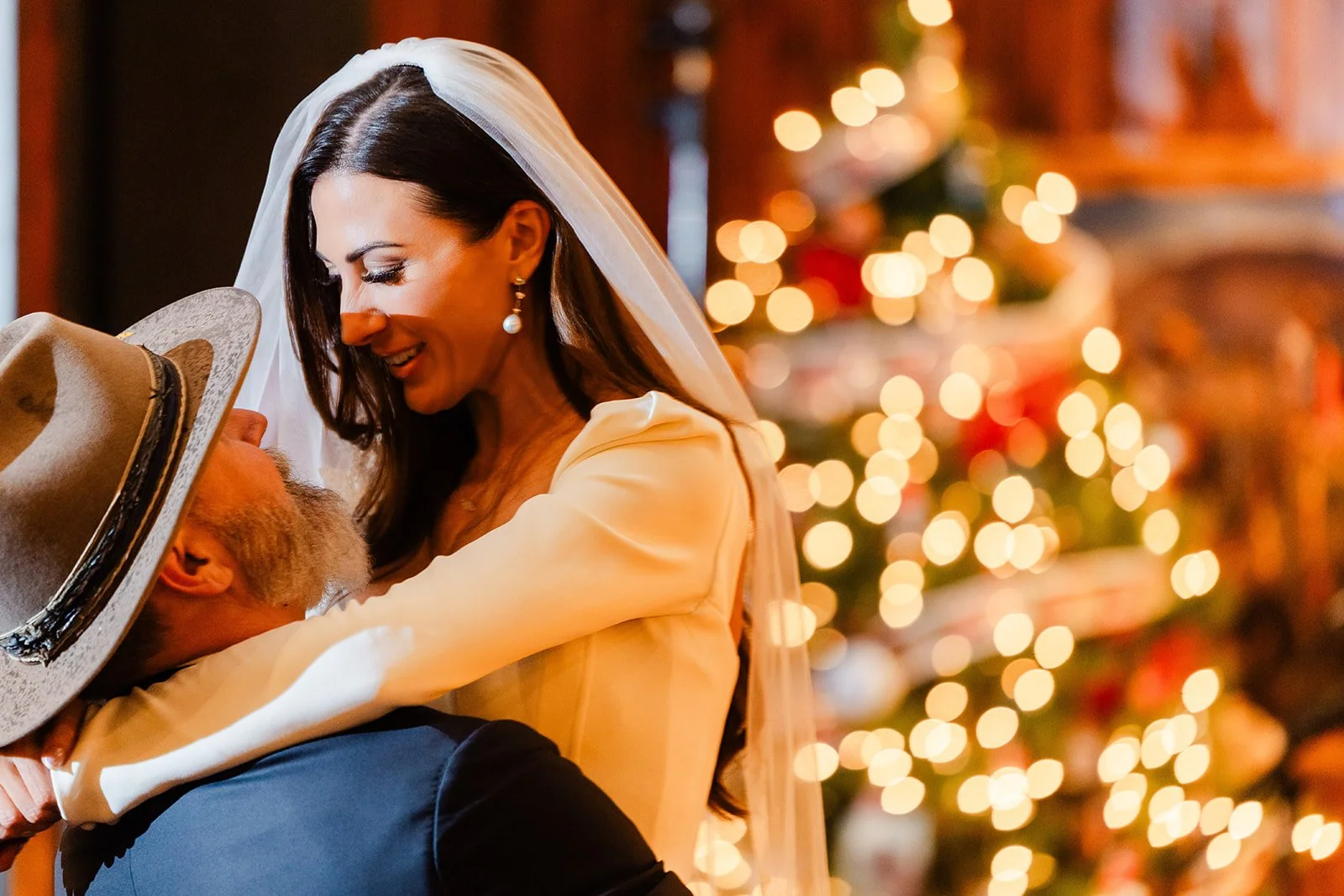 Winter luxury ranch wedding with couple doing first dance in front of the Christmas tree during holidays