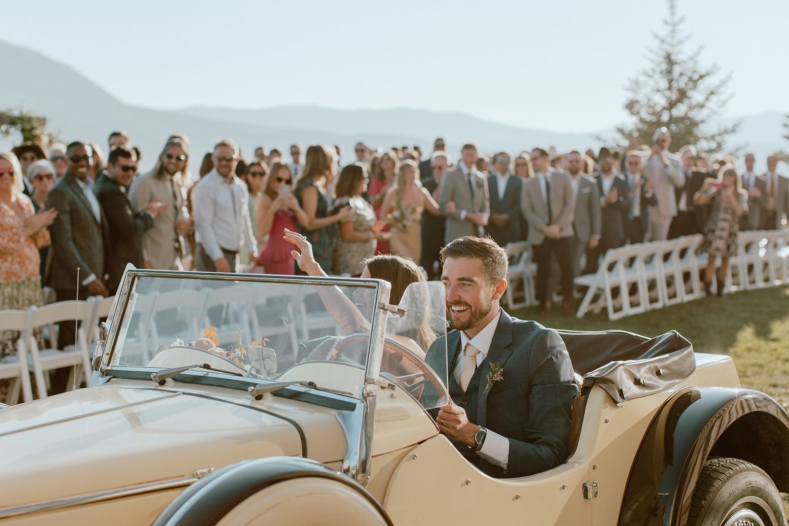 Couple leaving wedding in vintage car at luxury ranch wedding venue in Steamboat Springs