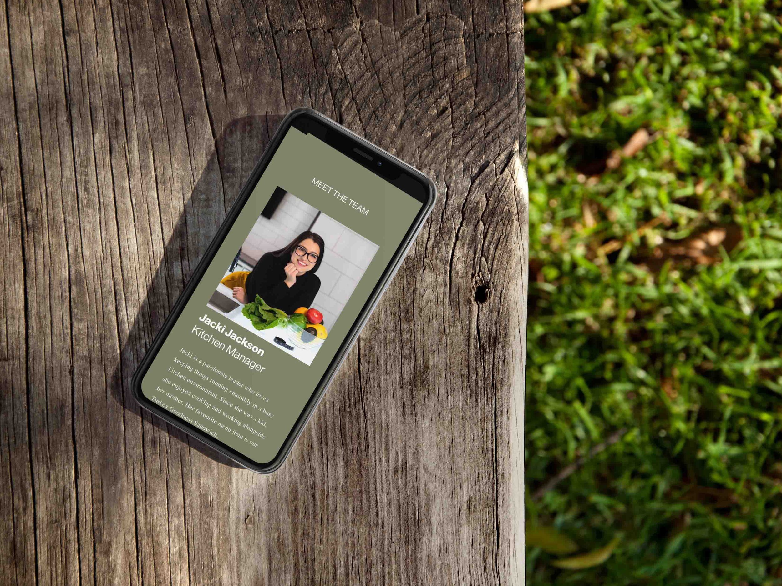 iphone-showing-restaurant-website-lying-on-a-wooden-bench-outdoors.jpg