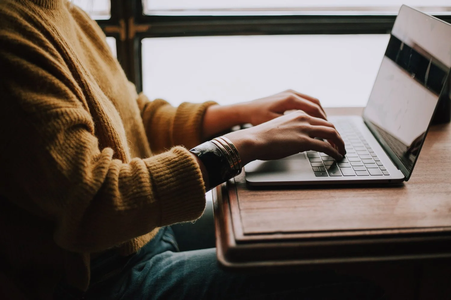 Person sitting at desk on laptop
