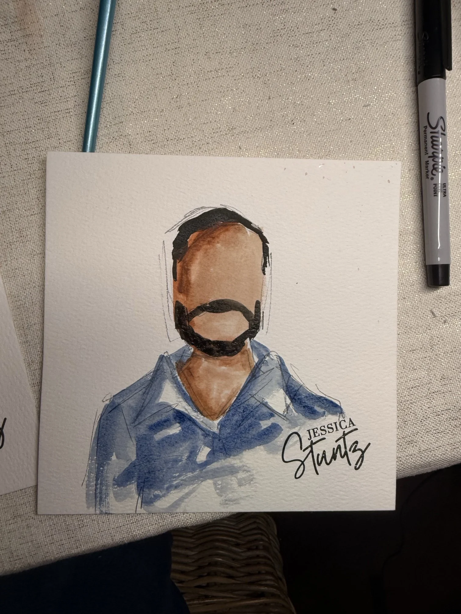 Watercolor wedding guest portrait of a man with a beard in a blue shirt, hand-painted on watercolor paper