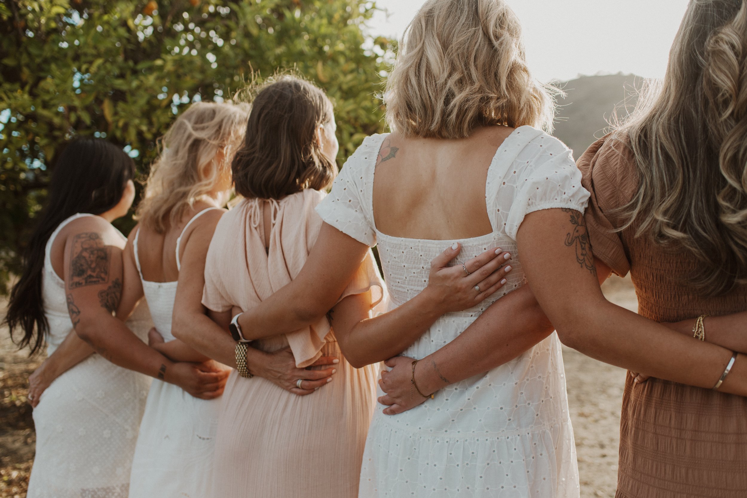 Birth and postpartum doulas with The Breezy Doula team hold each other for a photo in Orange County.