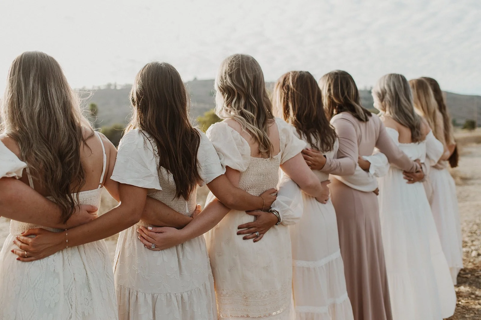 The Orange County doula team with The Breezy Doula holding hands in San Diego, California.