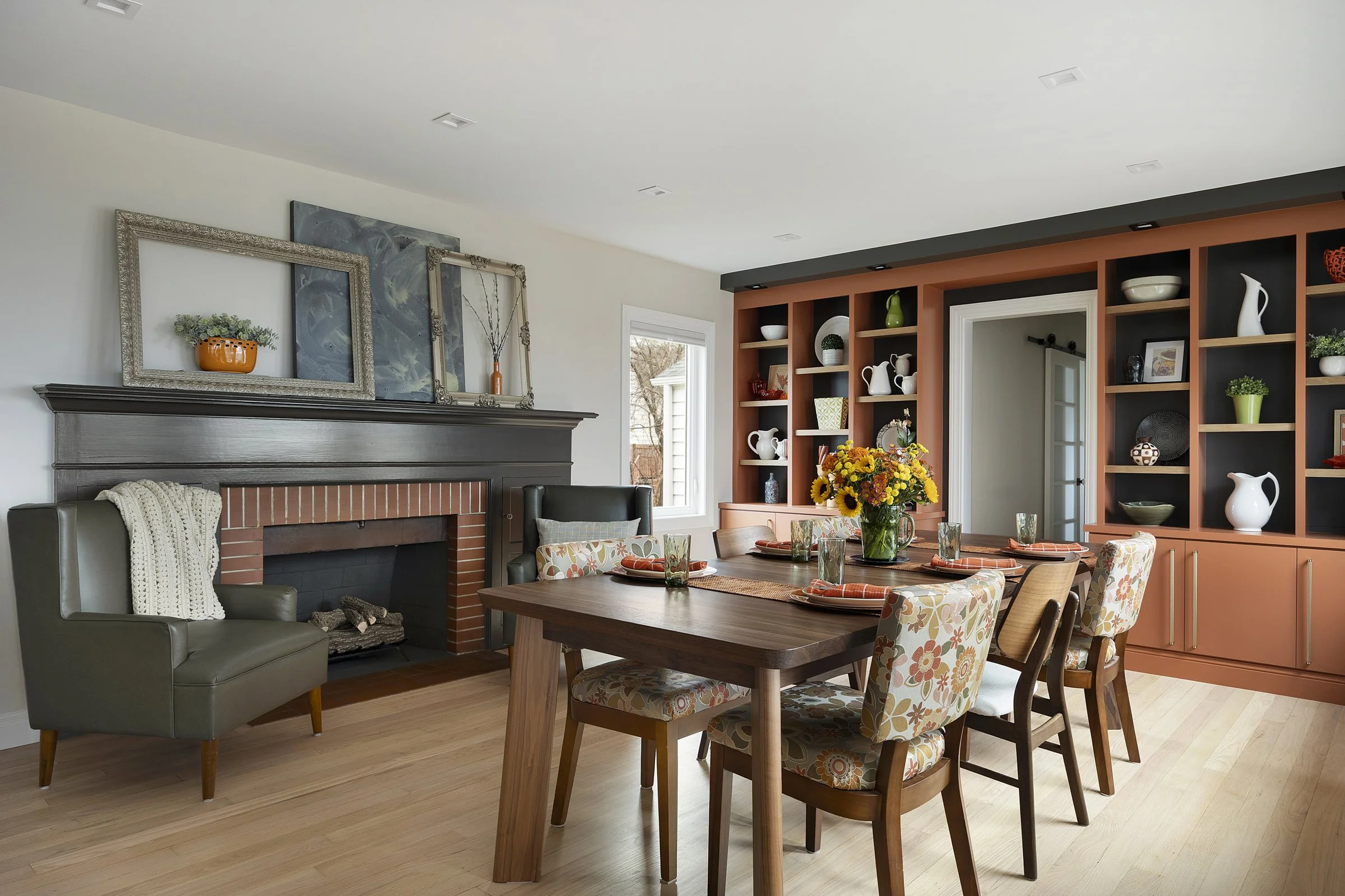 Dining Room remodel integrating existing brick  fireplace and new integrated bookshelves