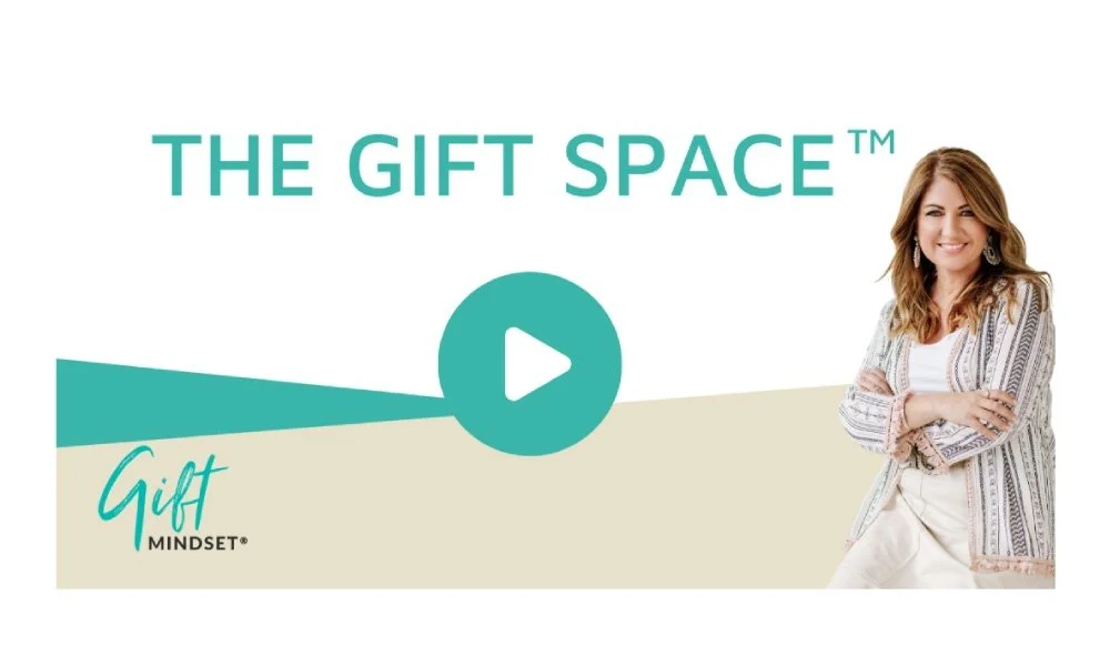 Title slide for 'The Gift Space' presentation featuring a woman smiling with crossed arms, wearing a patterned blazer and white top, with a play button icon in the center.