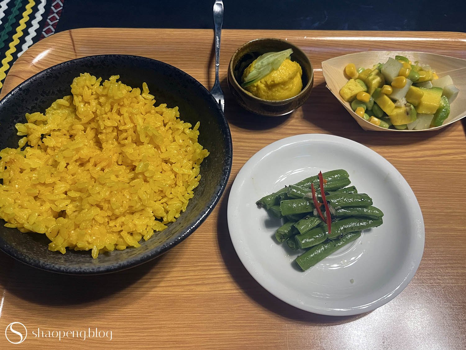 Turmeric rice is served with refreshing side dishes.