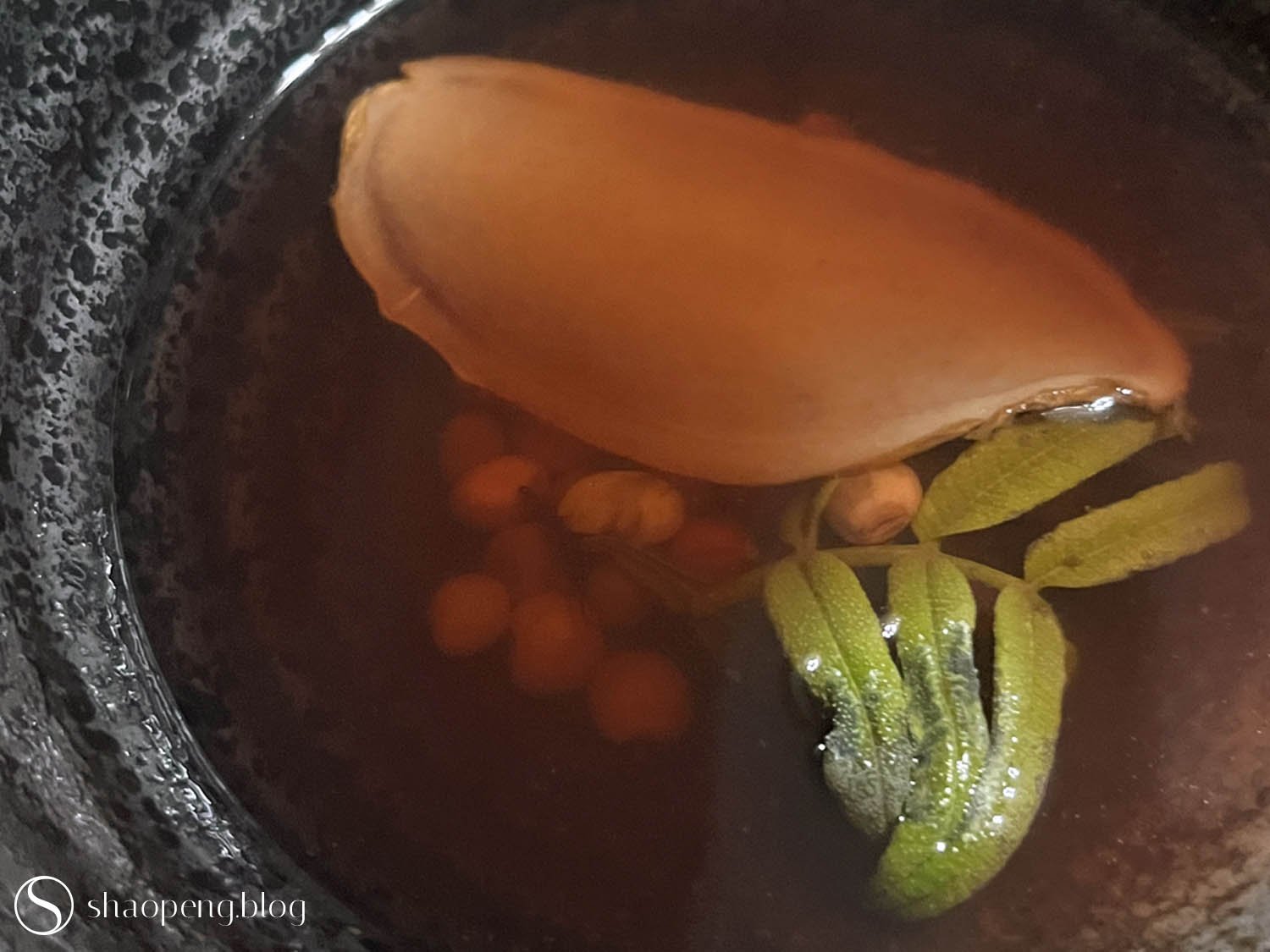 Pigeon pea soup with aged ginger and indigenous herbs.