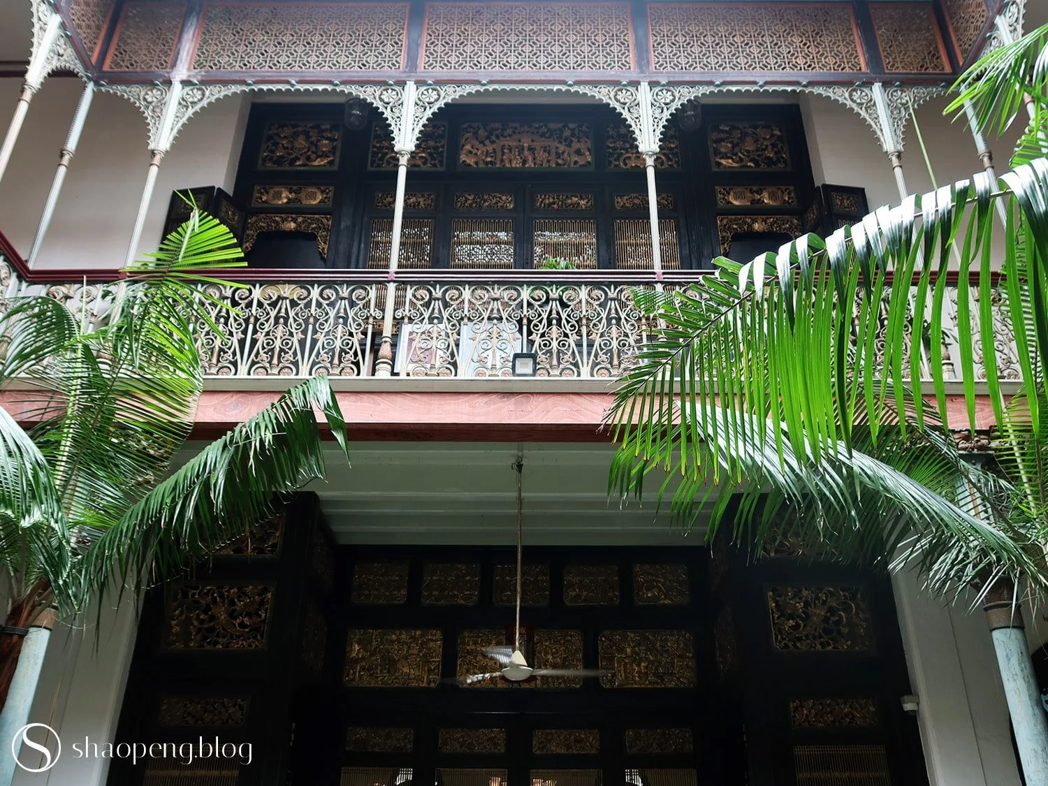 The juxtaposition of Scottish cast-iron balusters and Cantonese timber lattices is just one example of the eclectic beauty that defines Peranakan architecture.