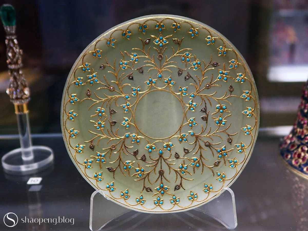 Dated to around 1900, this jade saucer is beautifully inlaid with gold, diamonds, and turquoise.