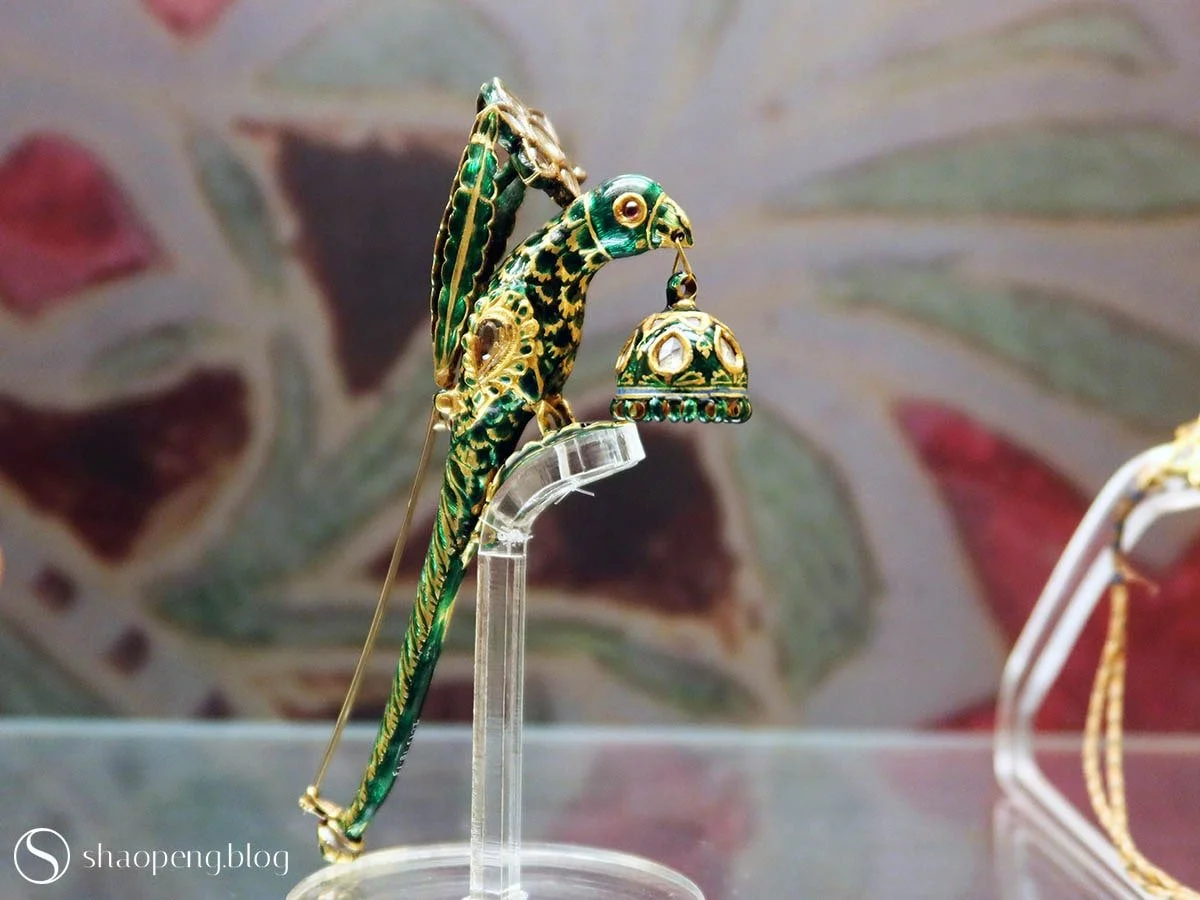 This parrot brooch sparkles with diamonds and is brought to life with vivid green enamel.
