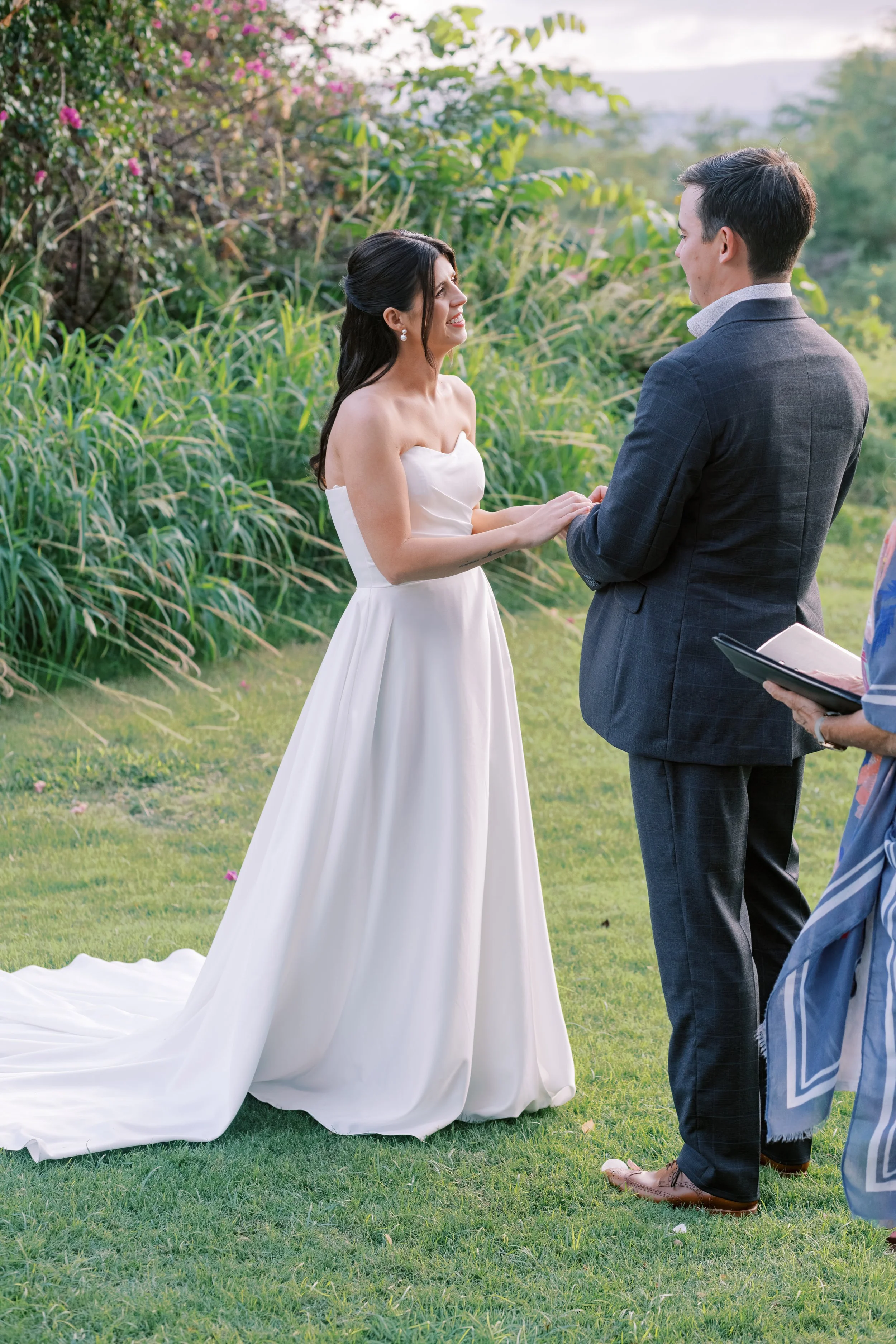A bride puts on her wedding ring at Gather on Wailea main lawn space