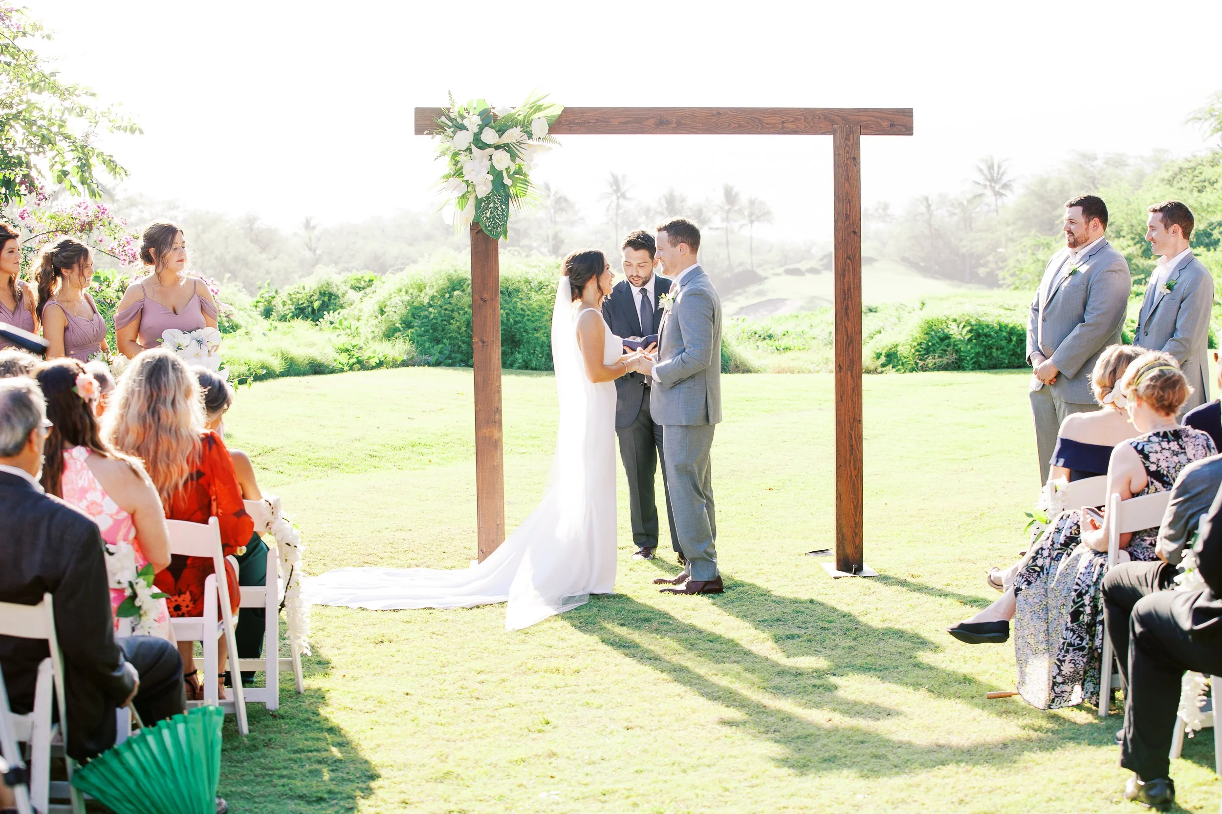 Bride and groom exchanging vows at the Wedding Knoll ceremony site at Gather on Maui.