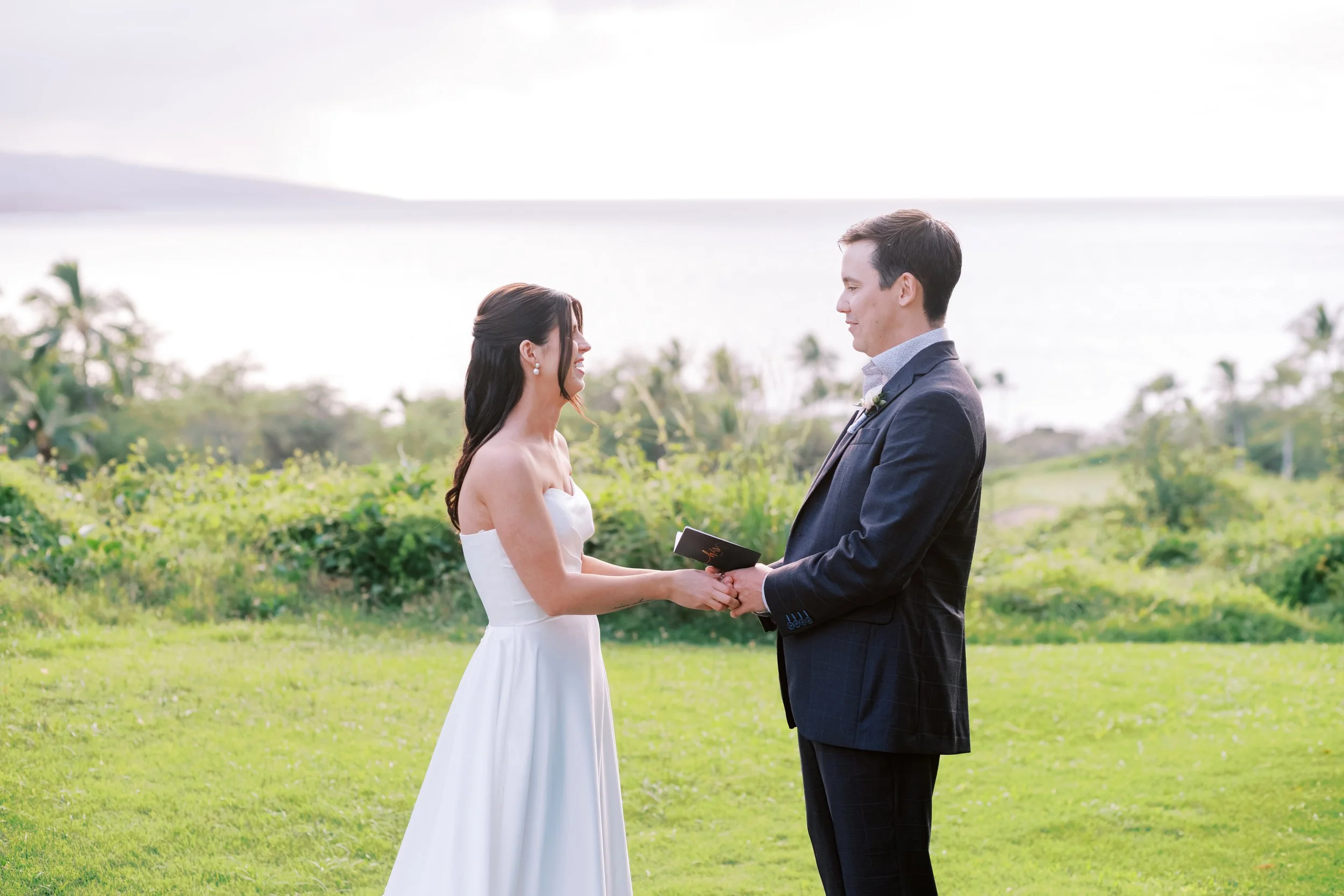 Bride and groom exchange vows on the main lawn at Gather on Wailea