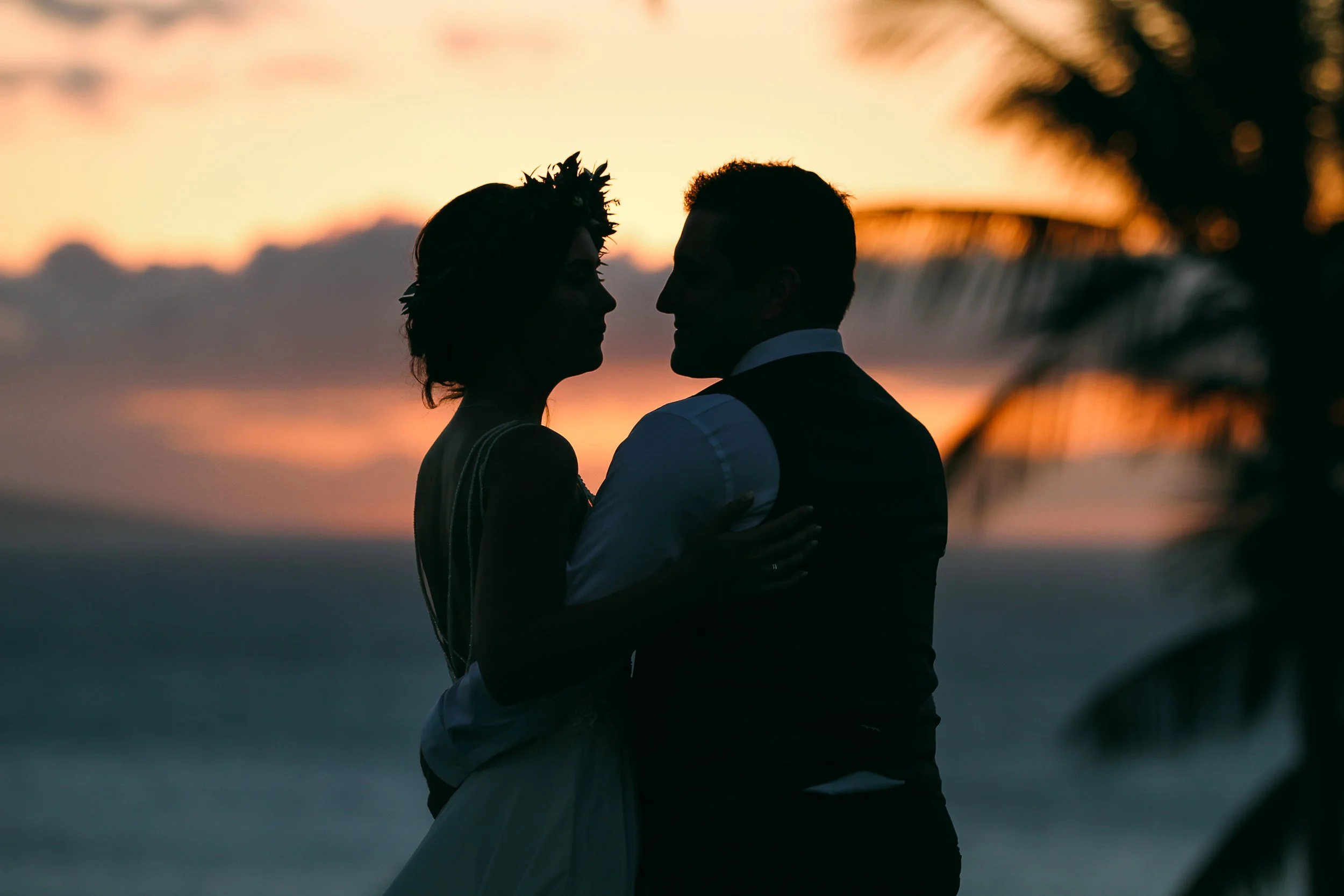 A wedding couple at sunset at the Four Seasons Resort Lanai