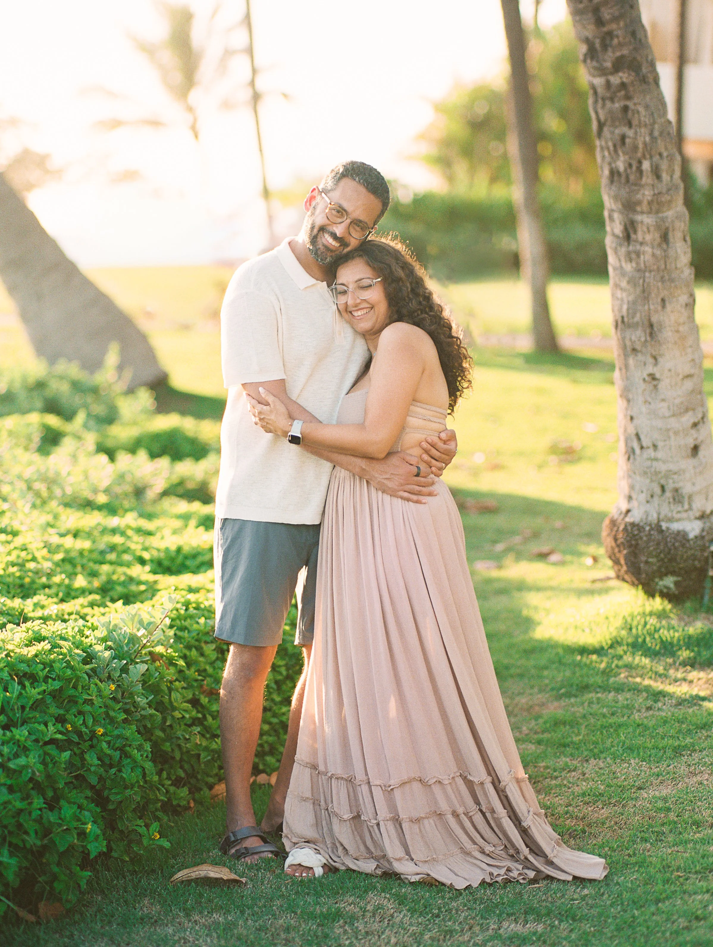 A couple having engagement photos during golden hour  captured on film at The Four Seasons Resort on Lanai.