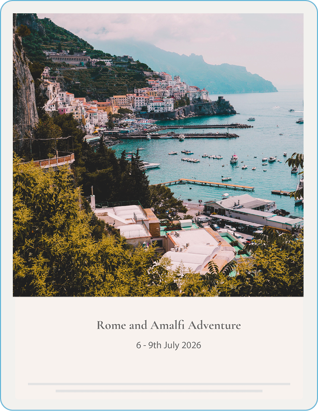 Scenic view of a coastal town with colorful buildings on cliffs, a harbor with boats, and green trees in Italy.