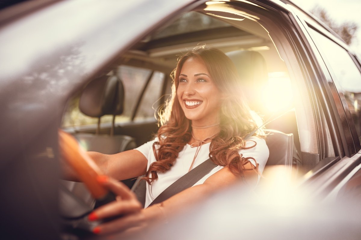 Happy woman in a car