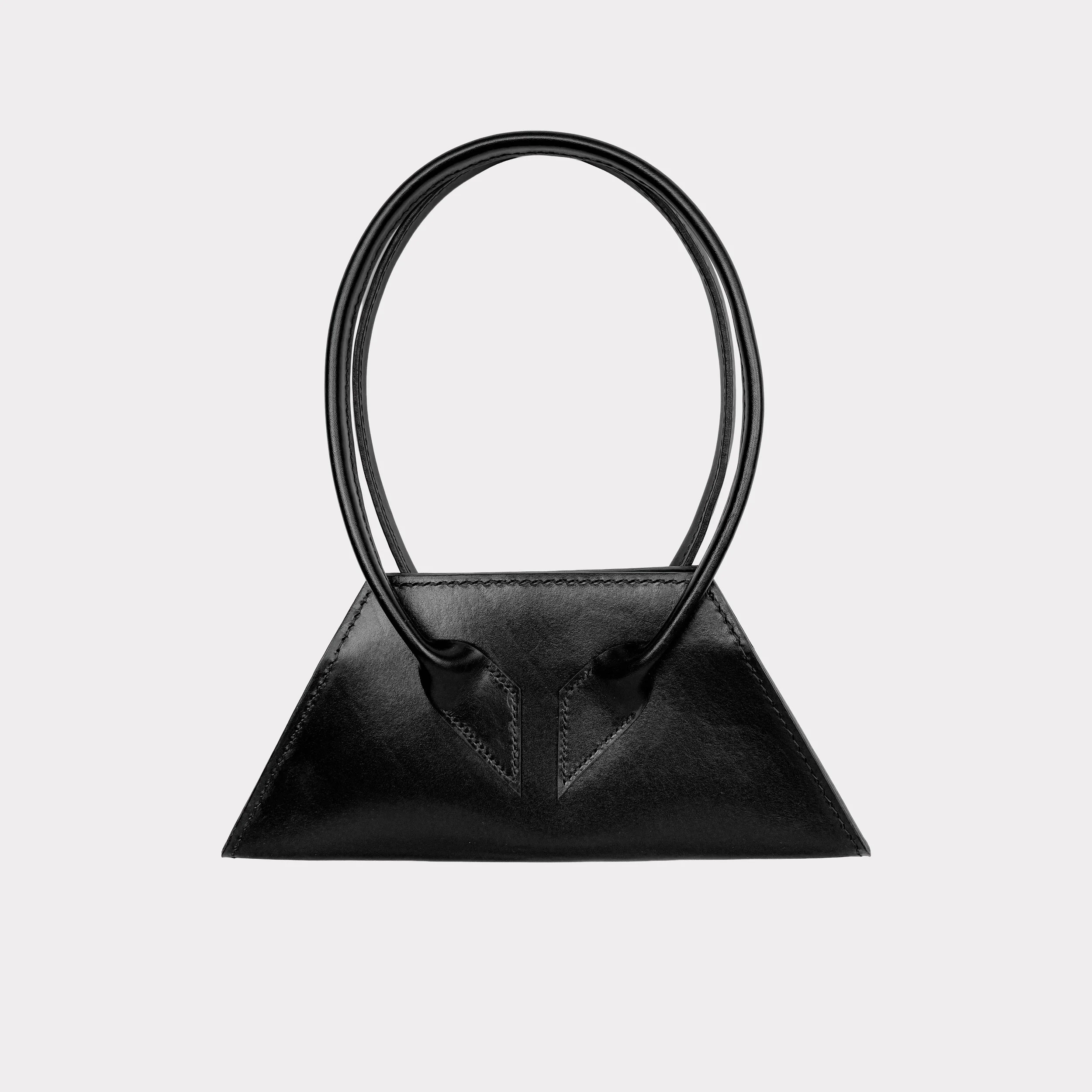 Black geometric handbag with round handles on a light gray background.