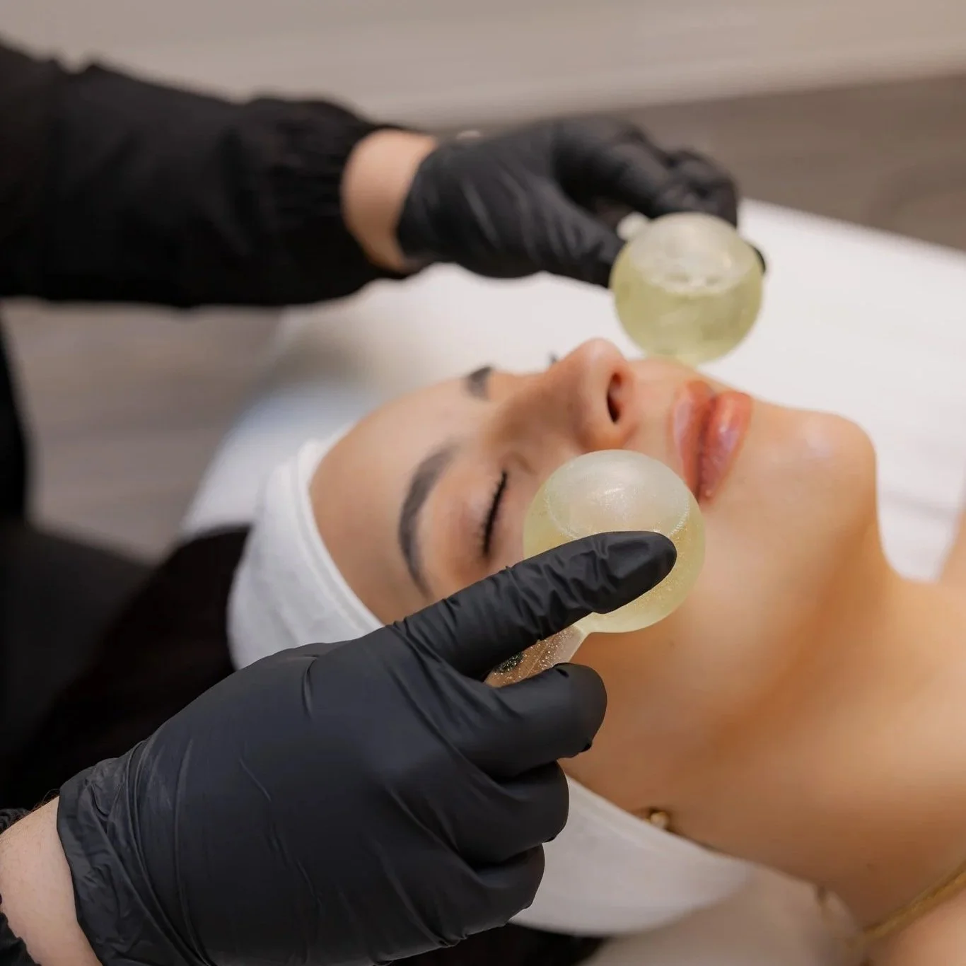 A provider at Morph Med Spa performing a facial cupping treatment on a client in the Ridgefield, CT treatment room.