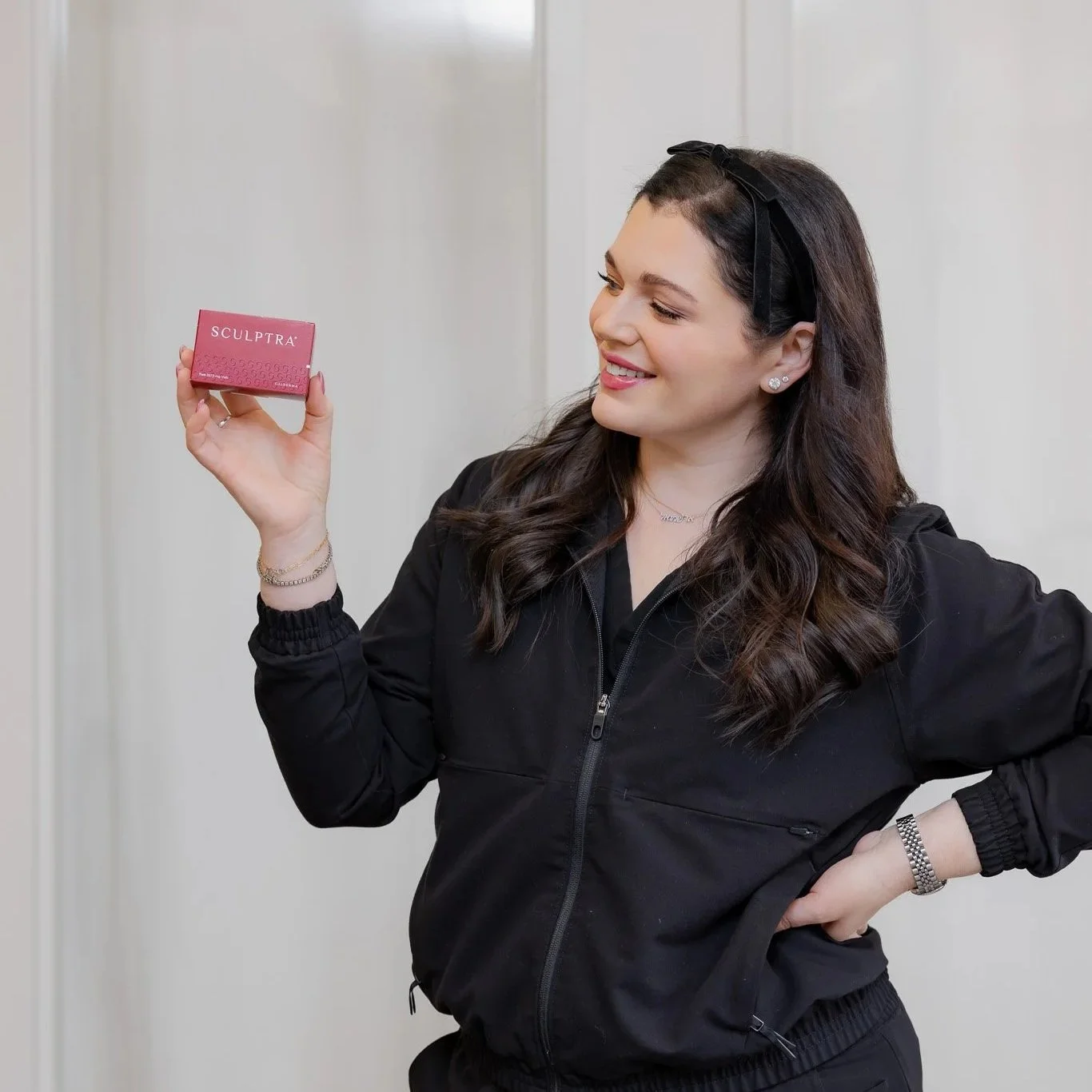 Amy Foxman, RN and Medical Aesthetic Provider at Morph Med Spa, holding a box of Sculptra biostimulator in Ridgefield, CT