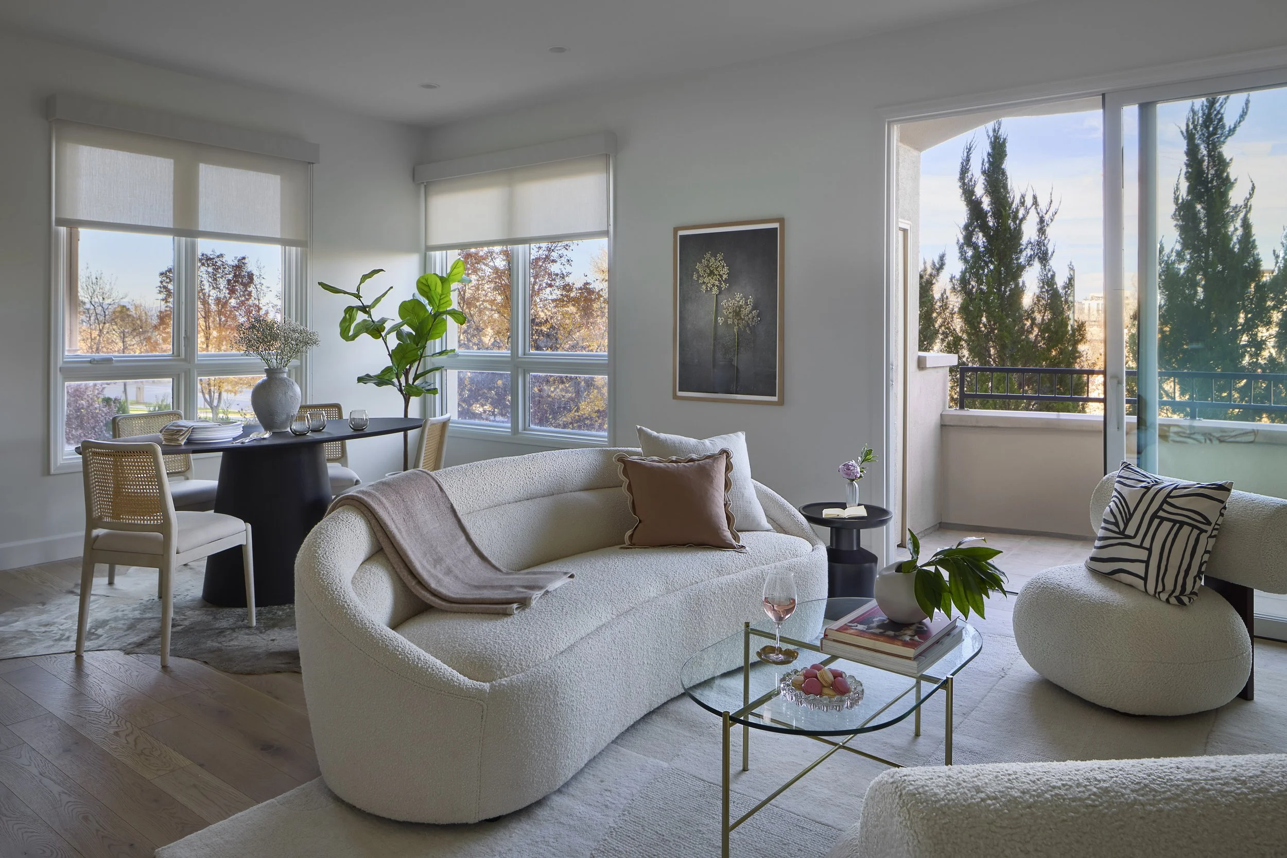 Living and dining areas designed by Flemming Interiors as part of a full condo renovation in Cherry Creek, Colorado, featuring curated furnishings, layered textures, and abundant natural light.