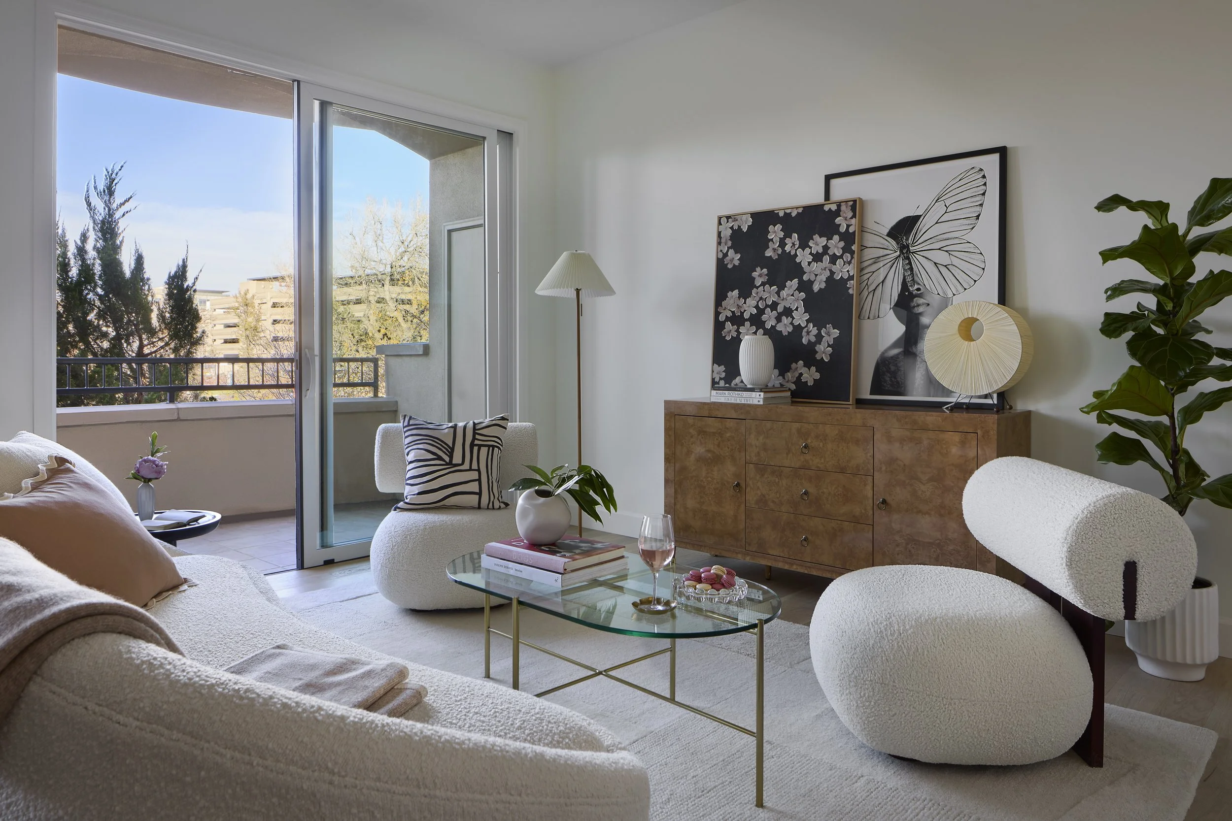Living room designed by Flemming Interiors as part of a full condo renovation in Cherry Creek, Colorado, featuring curated furnishings, layered textures, and access to a private balcony.