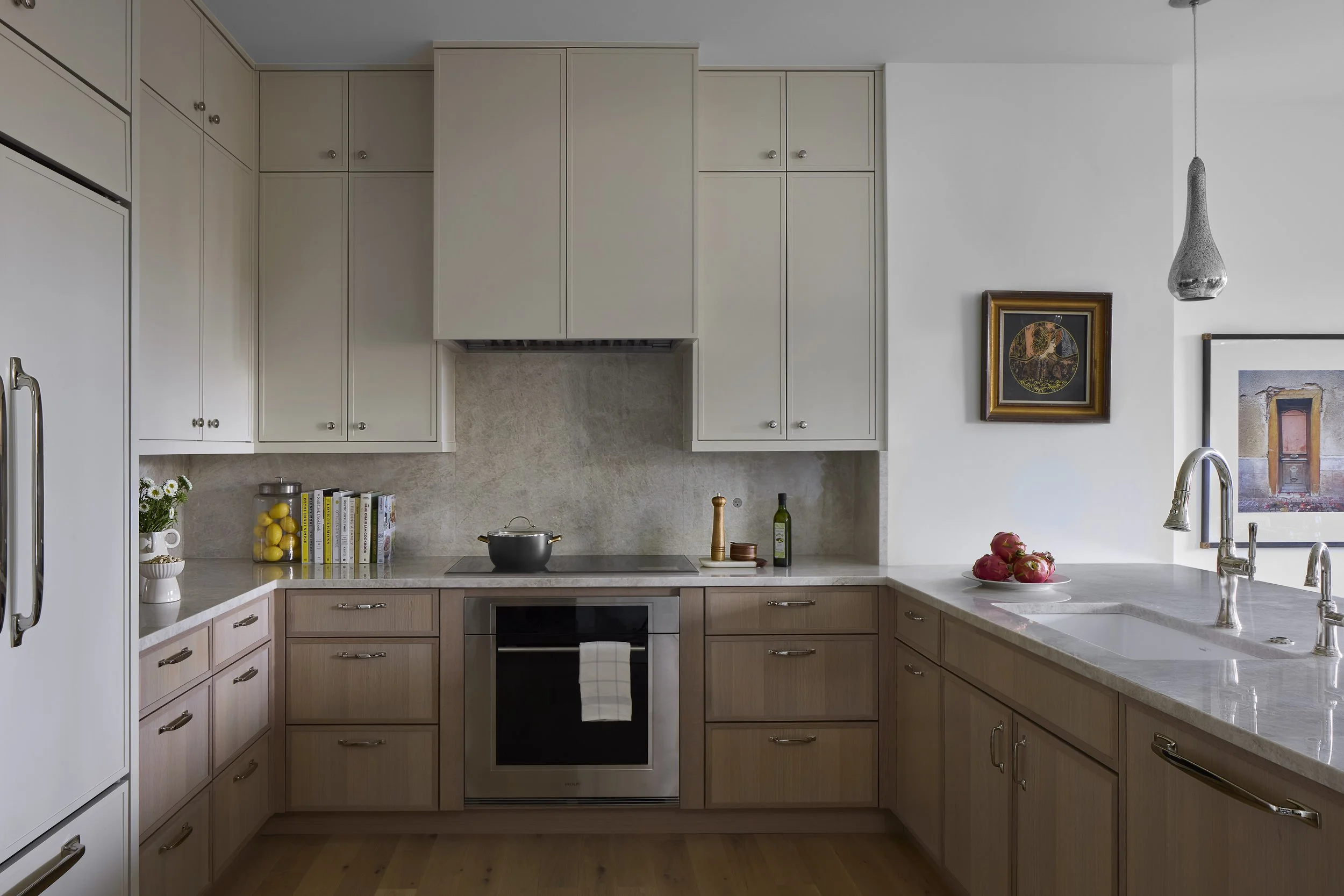 Custom kitchen designed by Flemming Interiors as part of a full condo renovation in Cherry Creek, Colorado, featuring integrated cabinetry, stone countertops, and refined architectural detailing.