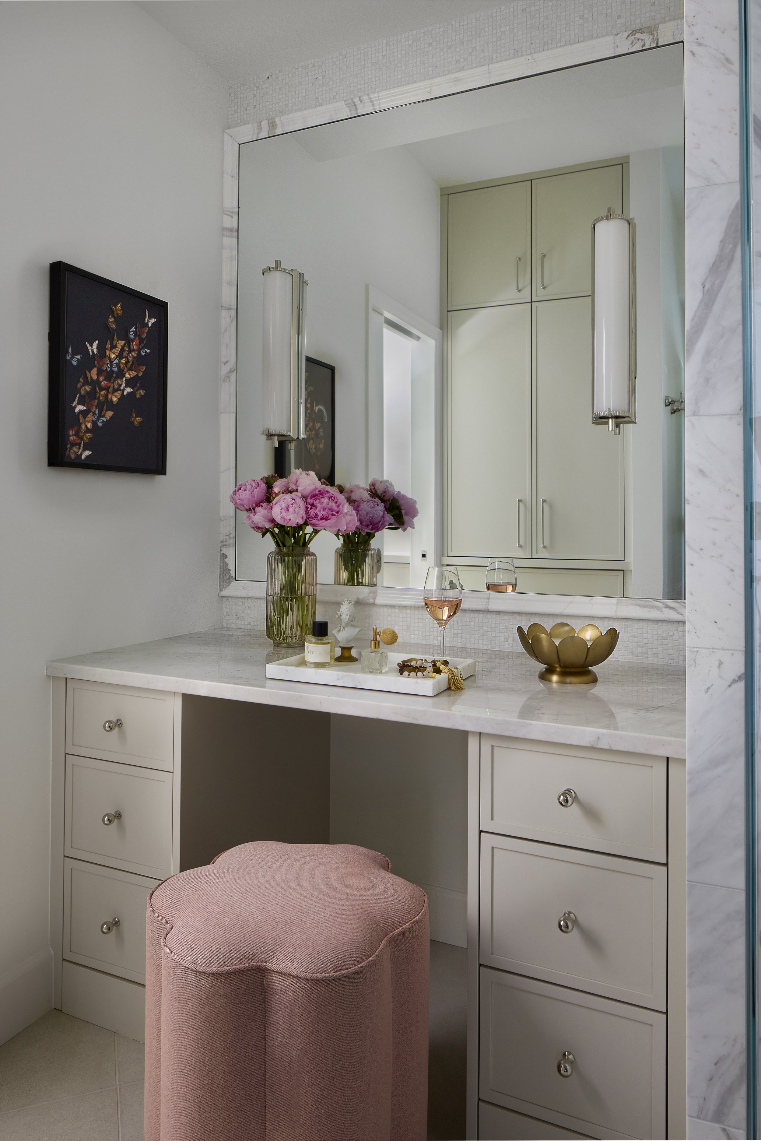 Primary bathroom vanity detail designed by Flemming Interiors in a Cherry Creek condo renovation, featuring custom cabinetry, marble surfaces, and integrated lighting.