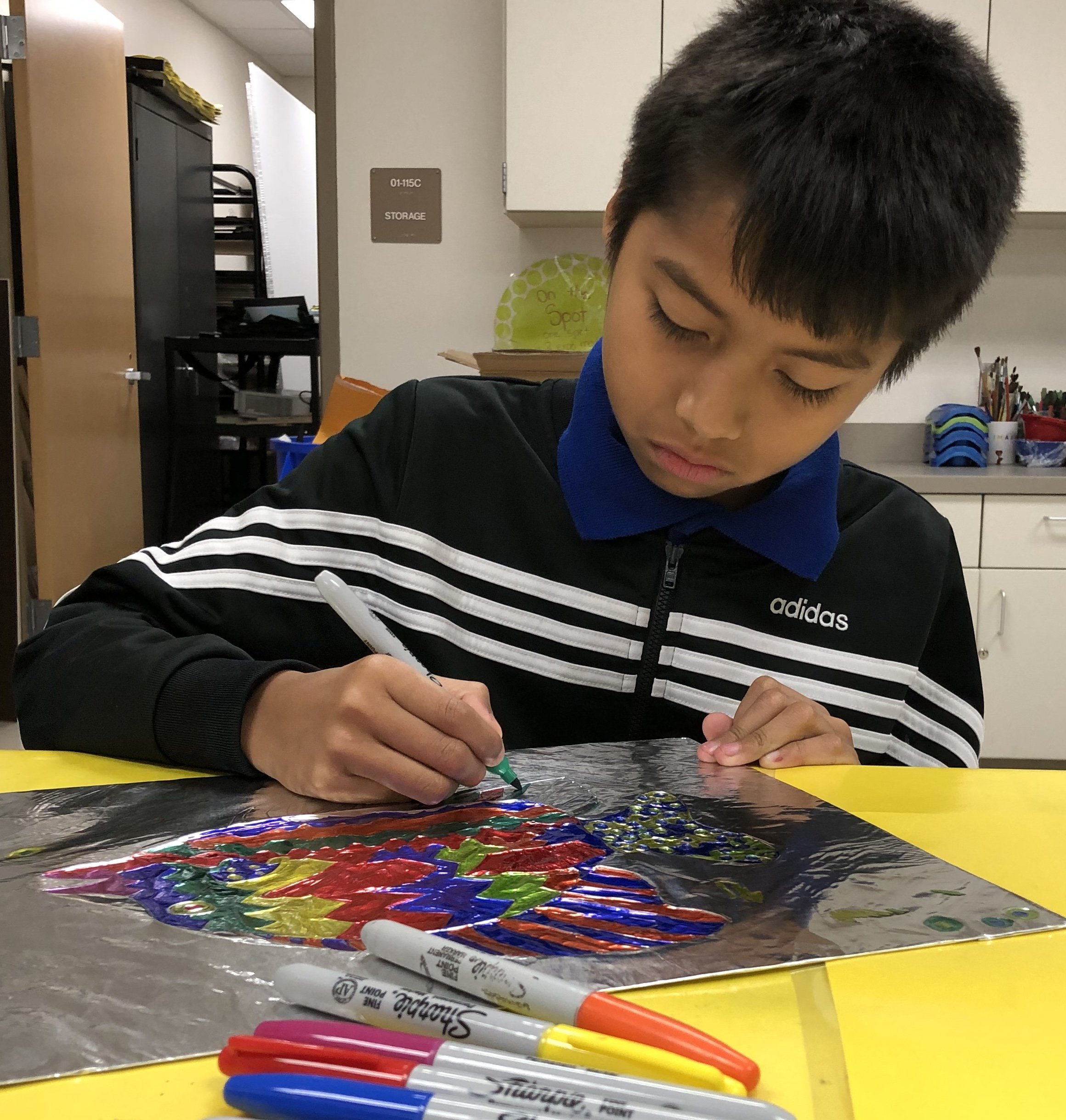 Boy coloring fish.jpeg
