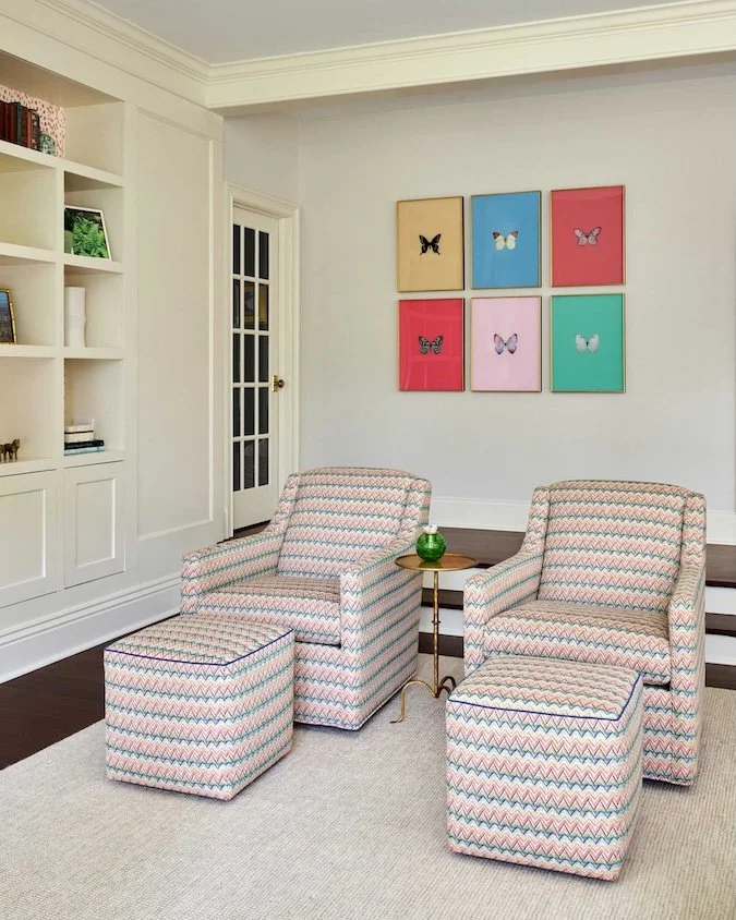 two-upholstered-chairs-with-butterfly-prints-above.jpg