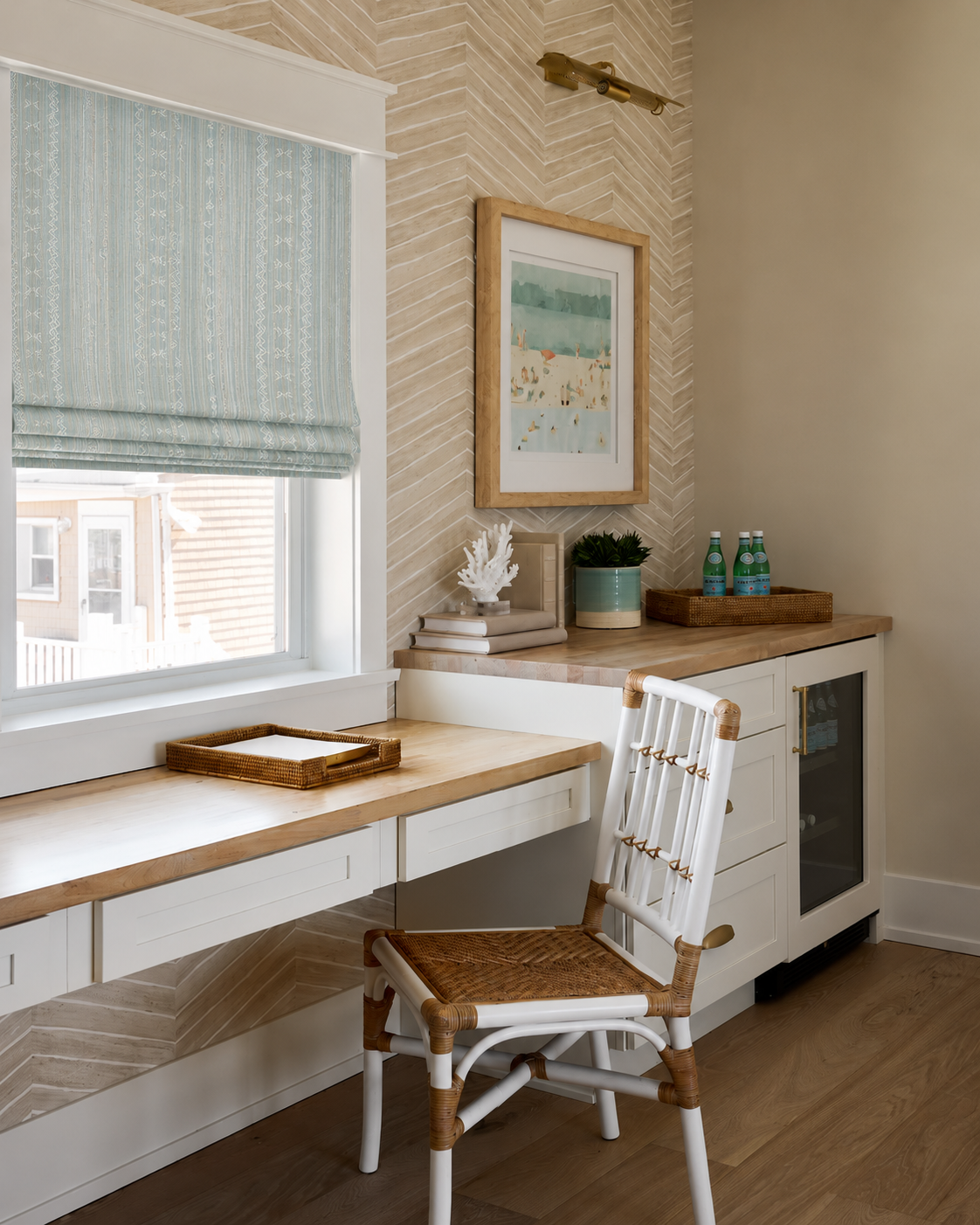 Home office overlooking a window with a cane chair and a three-drawer desk.