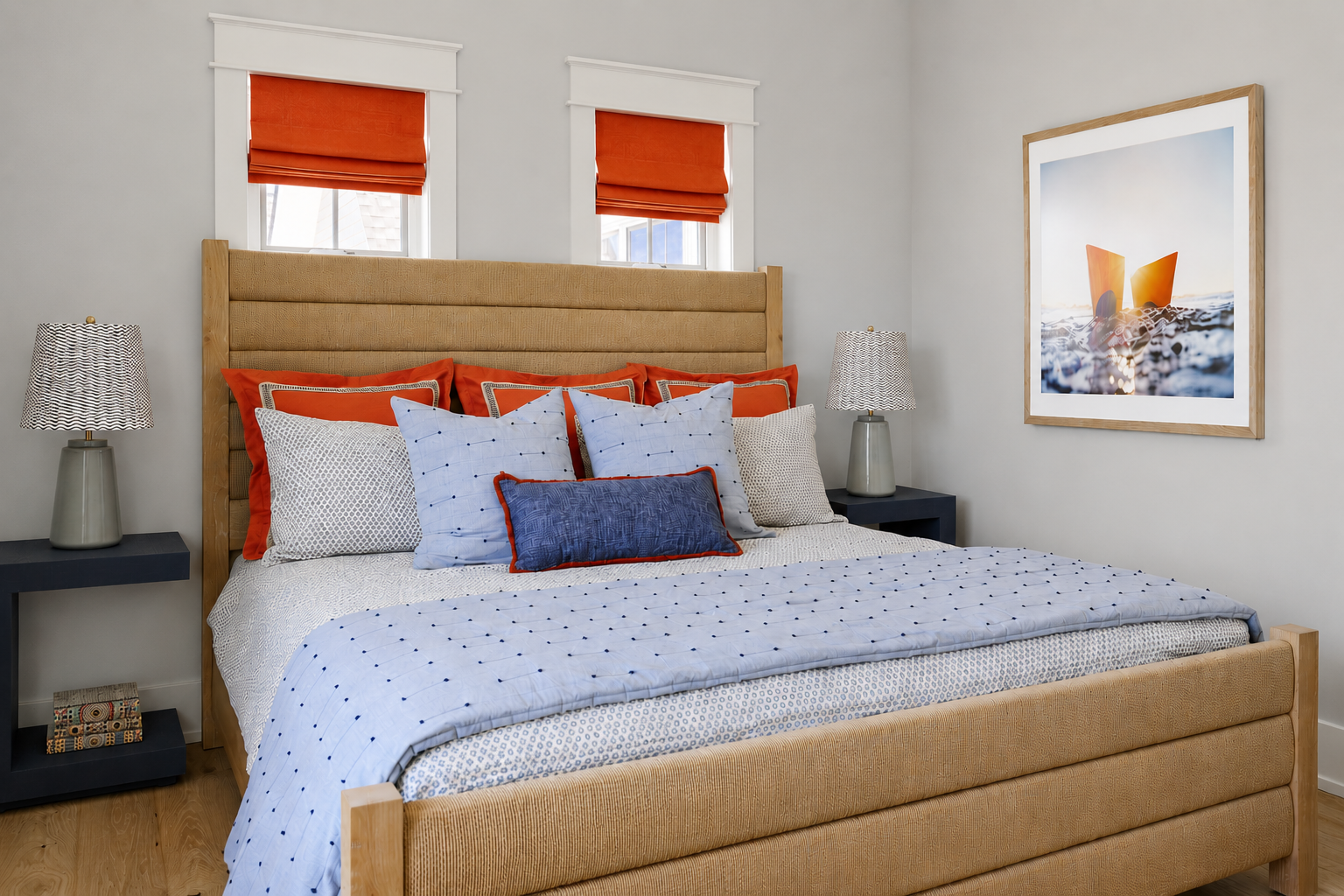 Bedroom with blue and orange themed pillows.