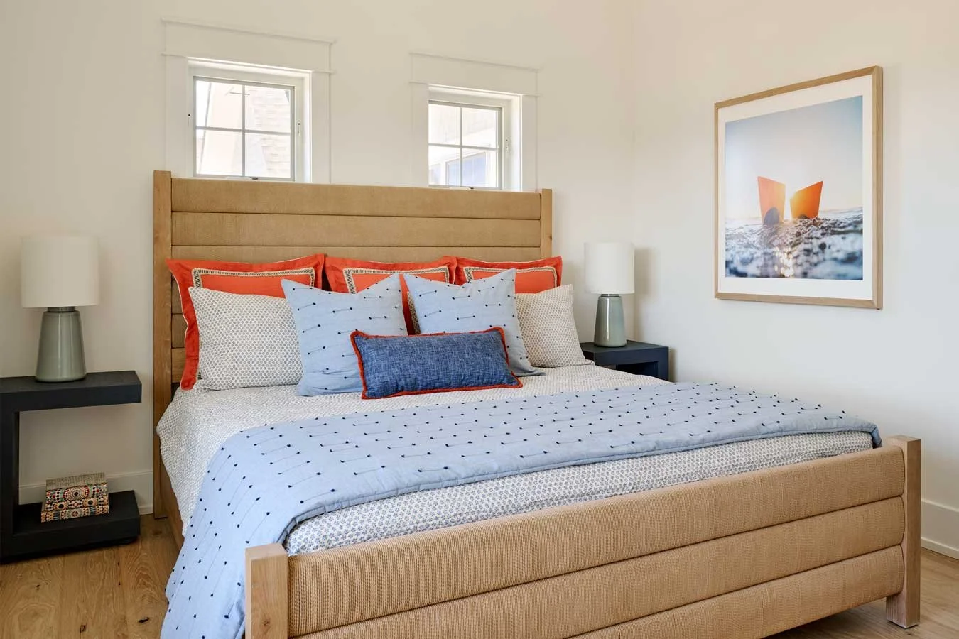 Bedroom with blue and red themed pillows.