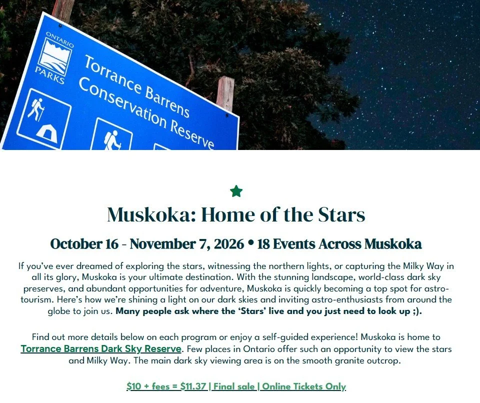 Blue informational sign for Torrance Barrens Conservation Reserve at night with stars in the sky and trees in the background.