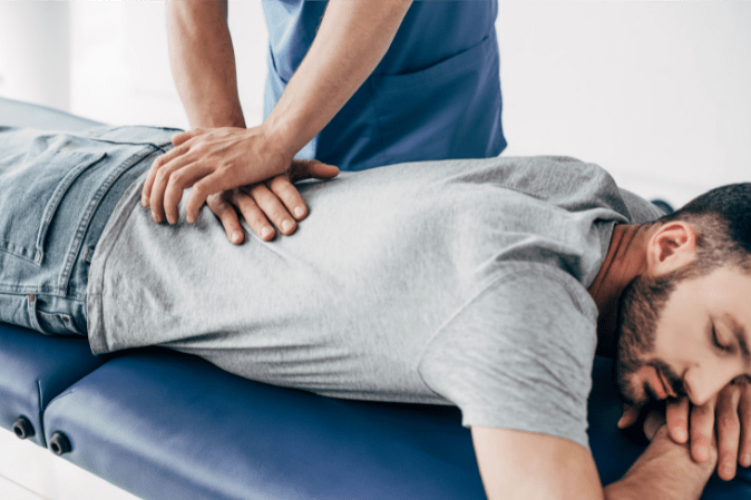 Chiropractor adjusting a patient's mid back at Mountain View Pain Center