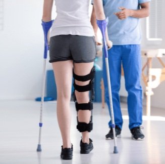Patient walking with crutches during post-surgical rehabilitation at Mountain View Pain Center
