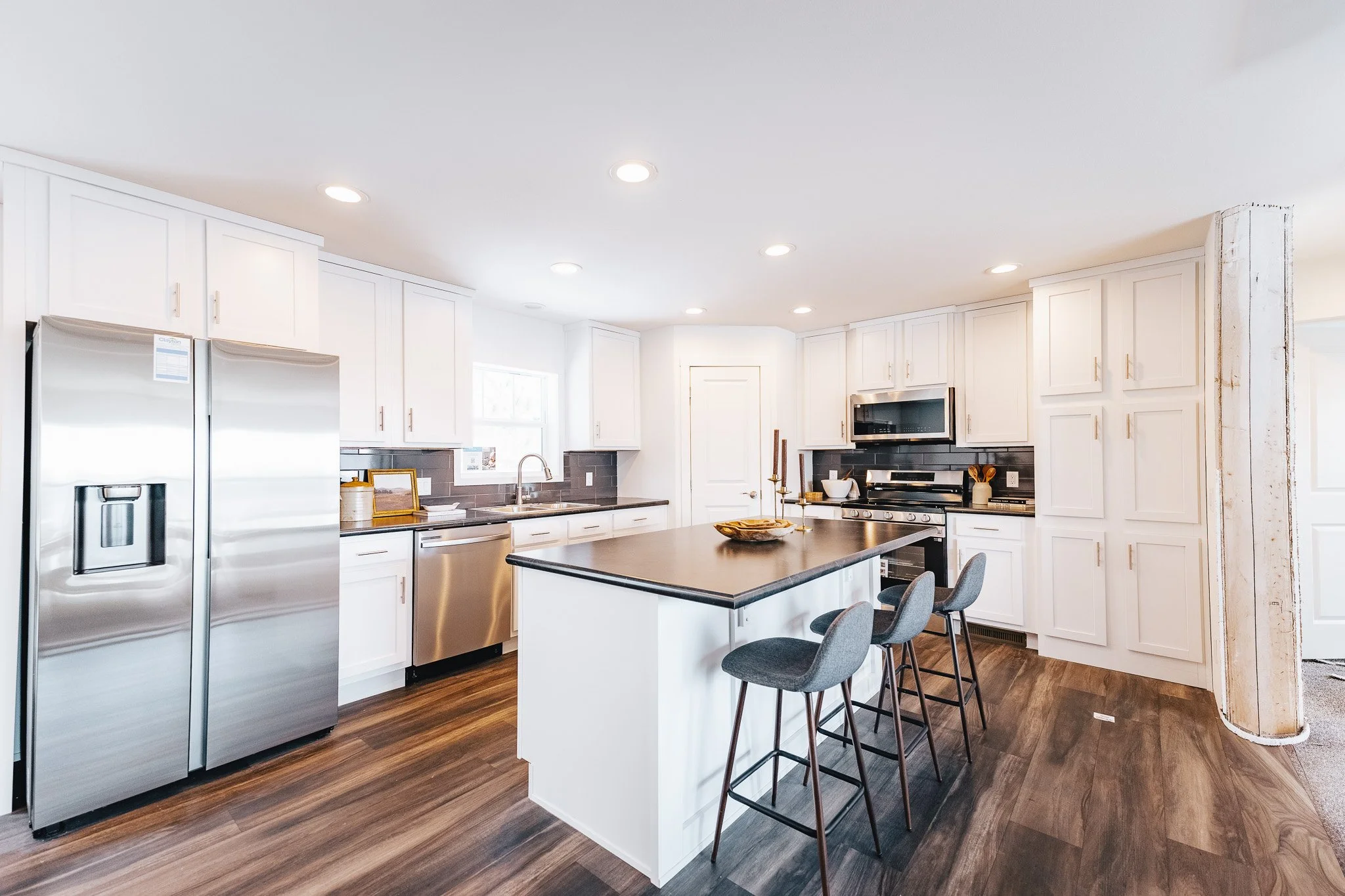 kitchen photo with white cabinets and stainless steel appliances inside the schult legend 327 manufactured home 