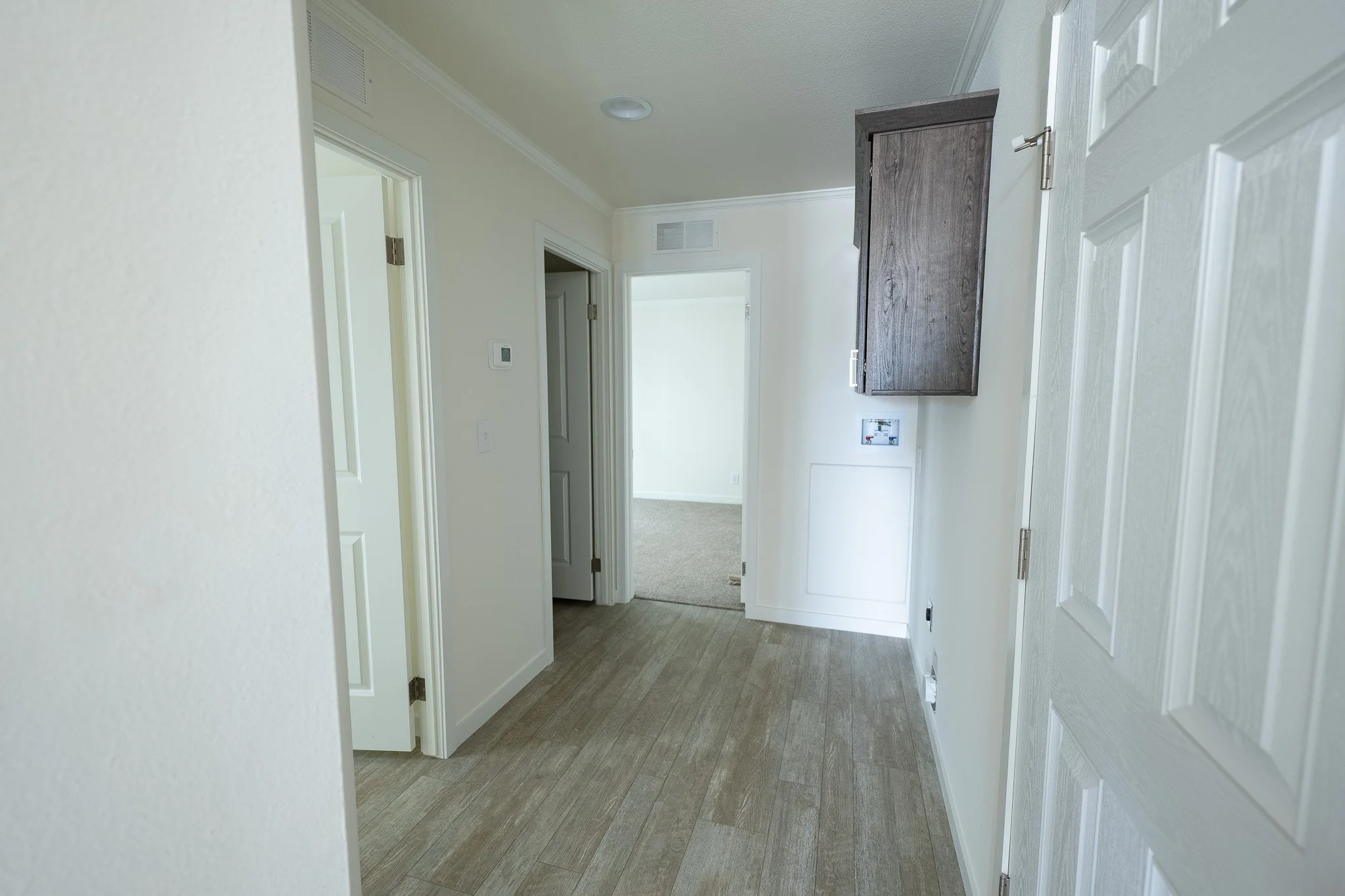 hallway photo with laundry area inside cavco singlewide home 