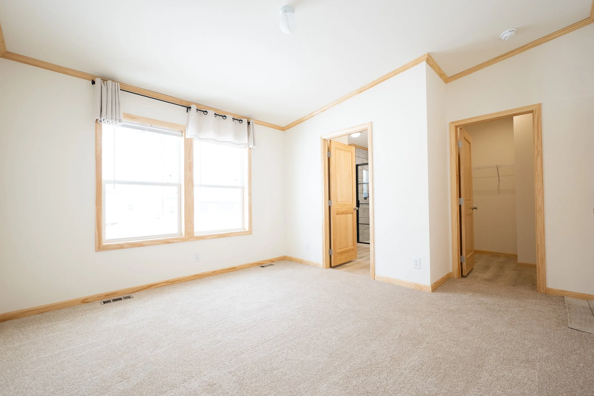 master bedroom photo with pine trim and a view of a walk in closet and into veiw of the master bathroom cavco westlake retreat 