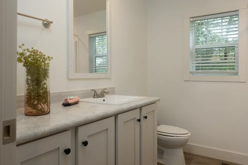 photo of secondary bathroom with single vanity and stool toilet insid ethe home schult tempo hey jude manufactured home