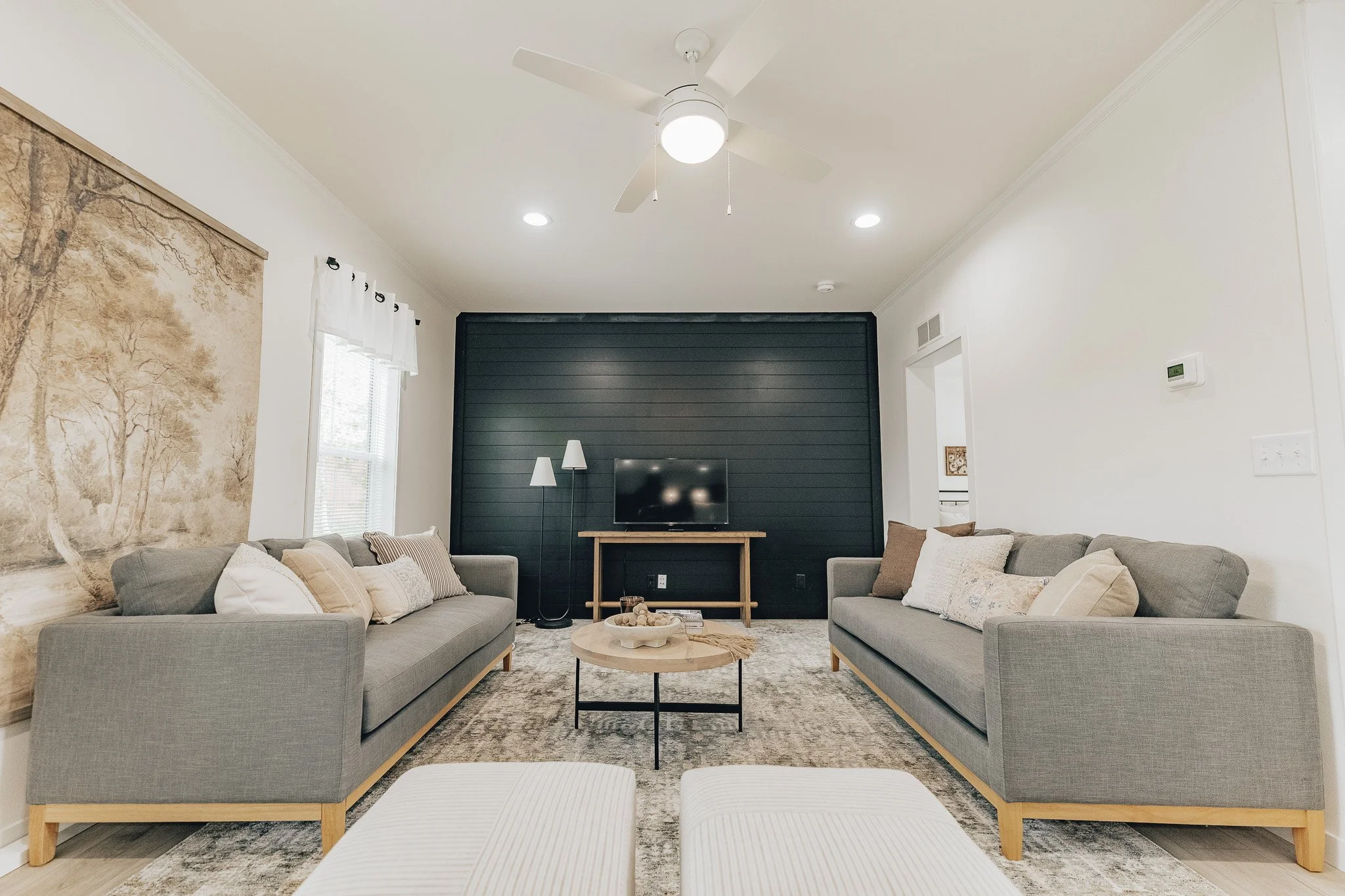 livingroom photo with black shiplap wall in the cavco farmhouse manufactured home