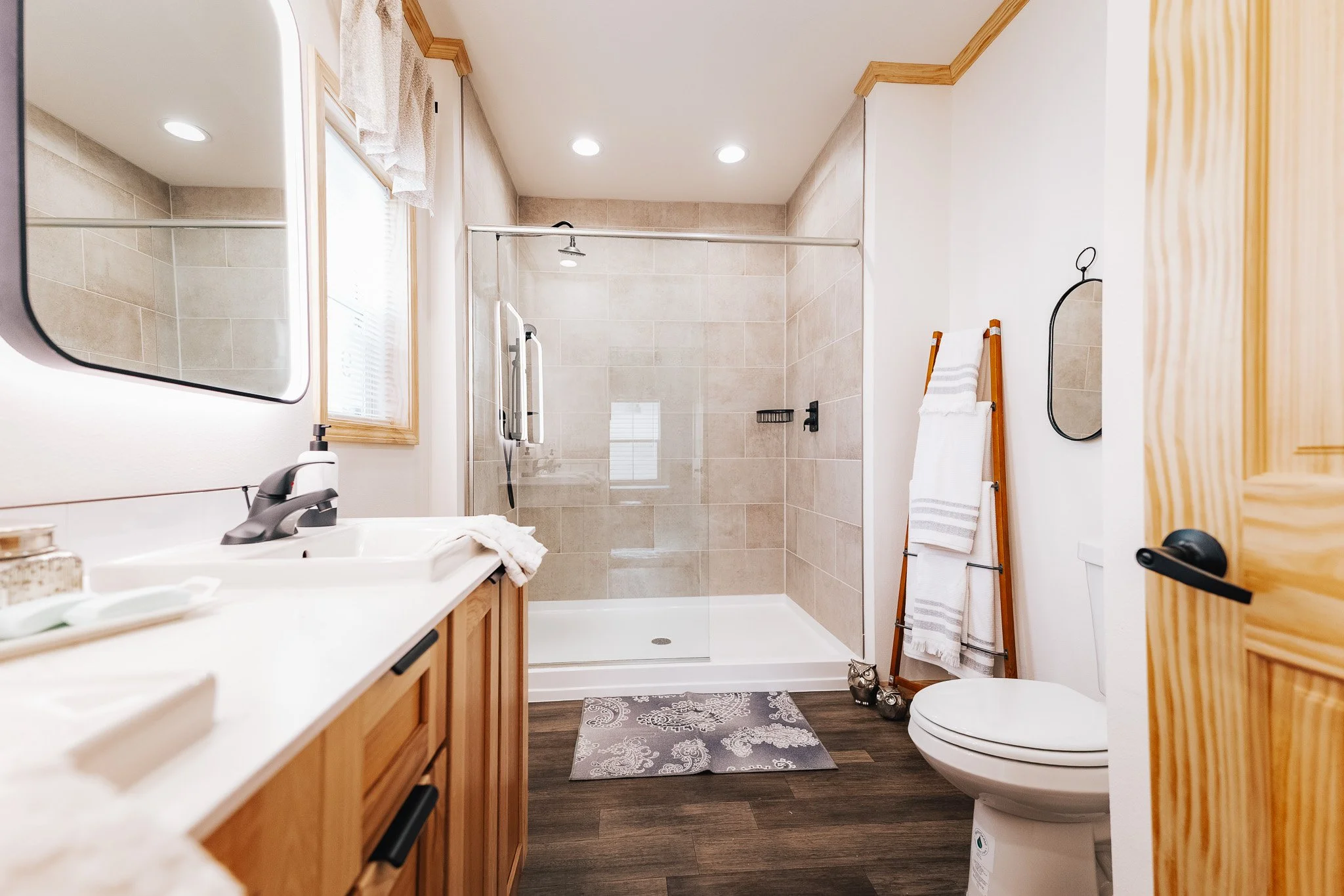 master bathroom photo with double vanity and walk in tiled shower 