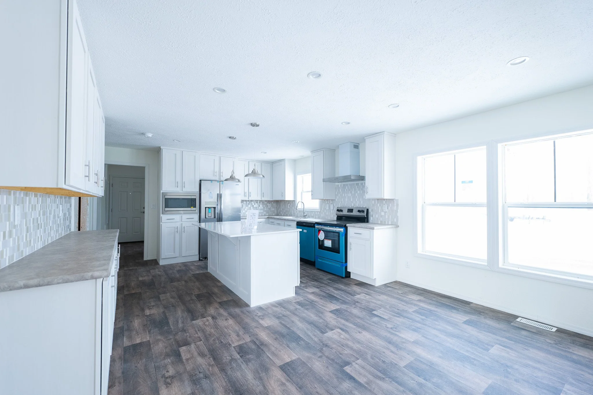 kitchen photo with white cabinets and granit  countertops in the legend 377 manufactured home 