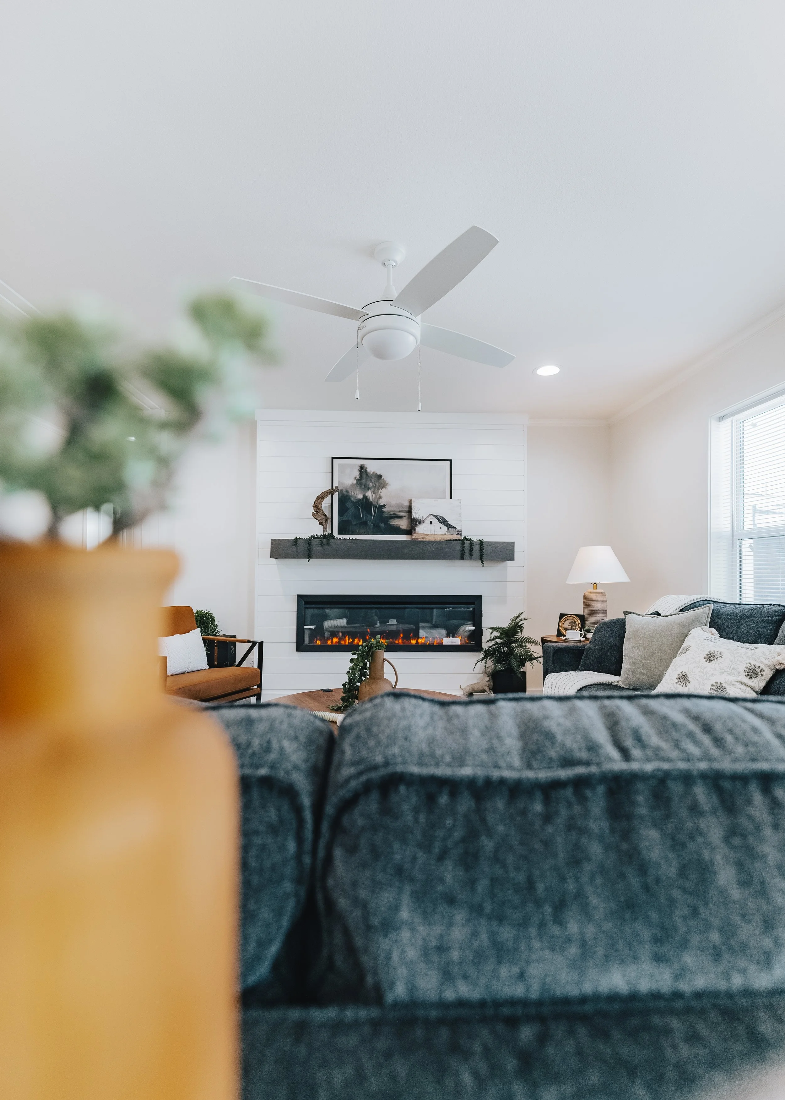 short and tight view of the fire place and mantal looking over the couch in the cavco farmhouse 