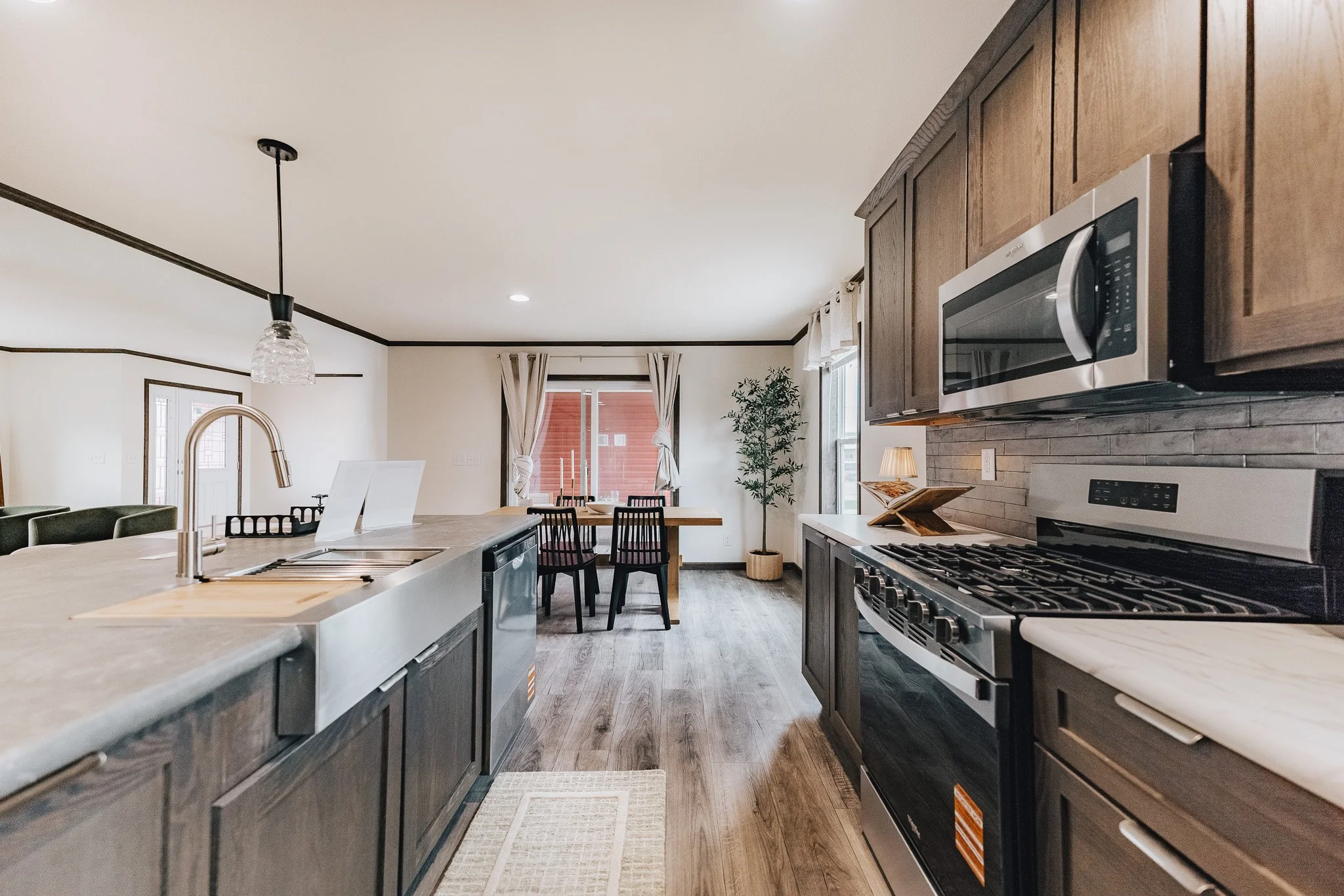 kitchen photo with gray cabinets and dinning room area to the left side of the photo